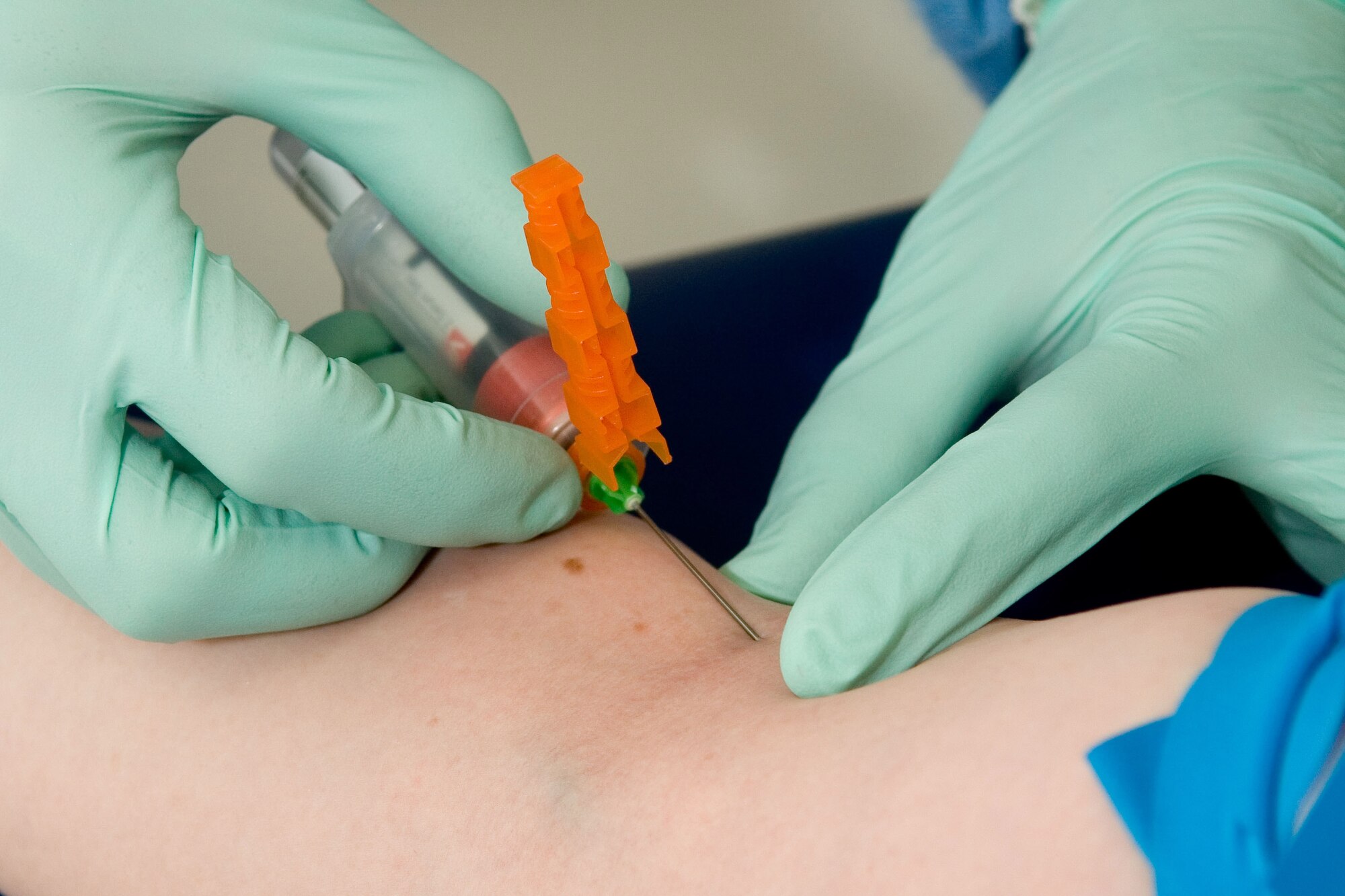 YOKOTA AIR BASE, Japan -- Staff. Sgt. Eduardo Garcia-Perez, 374th Medical Support Squadron laboratory craftsman, draws blood from a patient March 19 at the base hospital. (U.S. Air Force photo/Osakabe Yasuo)
