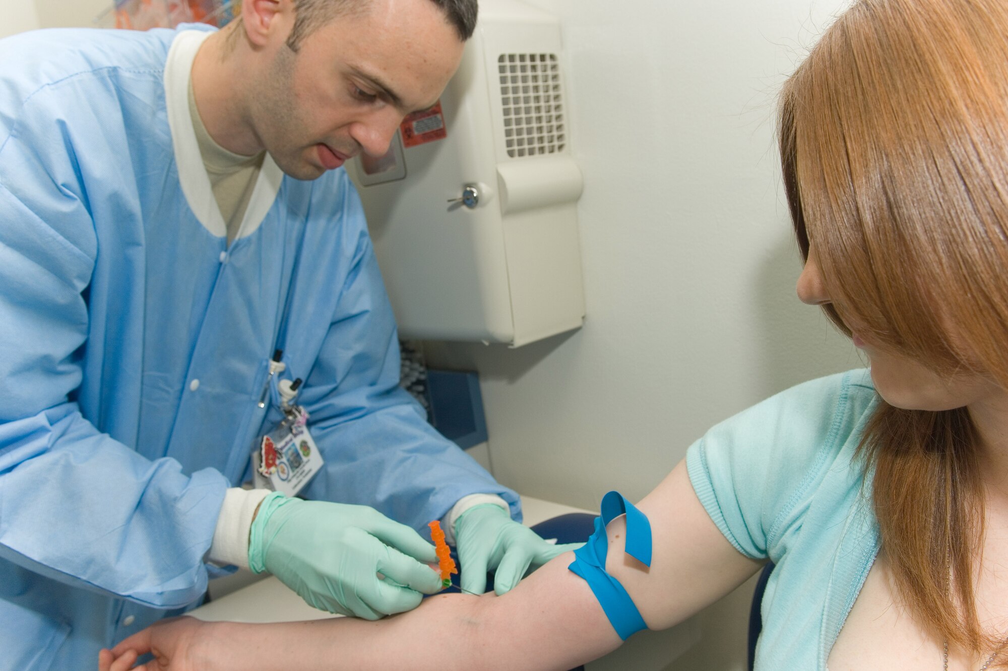YOKOTA AIR BASE, Japan -- Staff. Sgt. Eduardo Garcia-Perez, 374th Medical Support Squadron laboratory craftsman, draws blood from a patient March 19 at the base hospital. (U.S. Air Force photo/Osakabe Yasuo)
