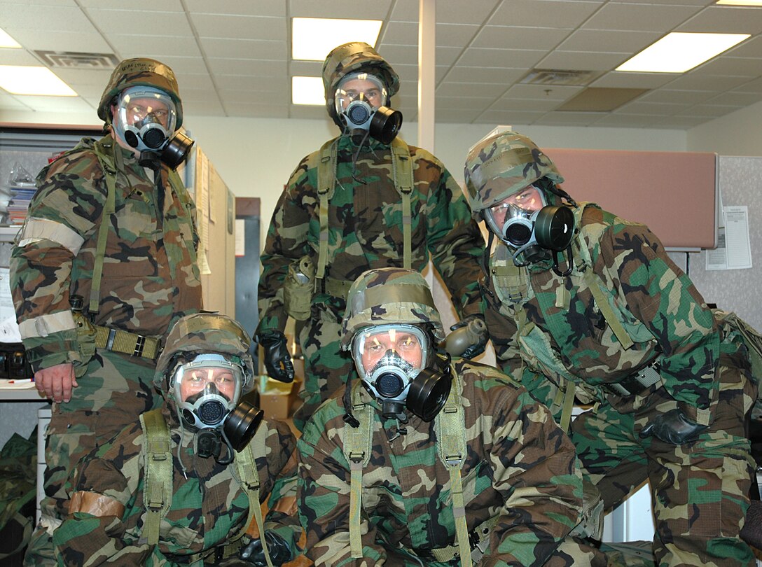 The Wing Chaplains pose for a group photo in full MOPP gear.
