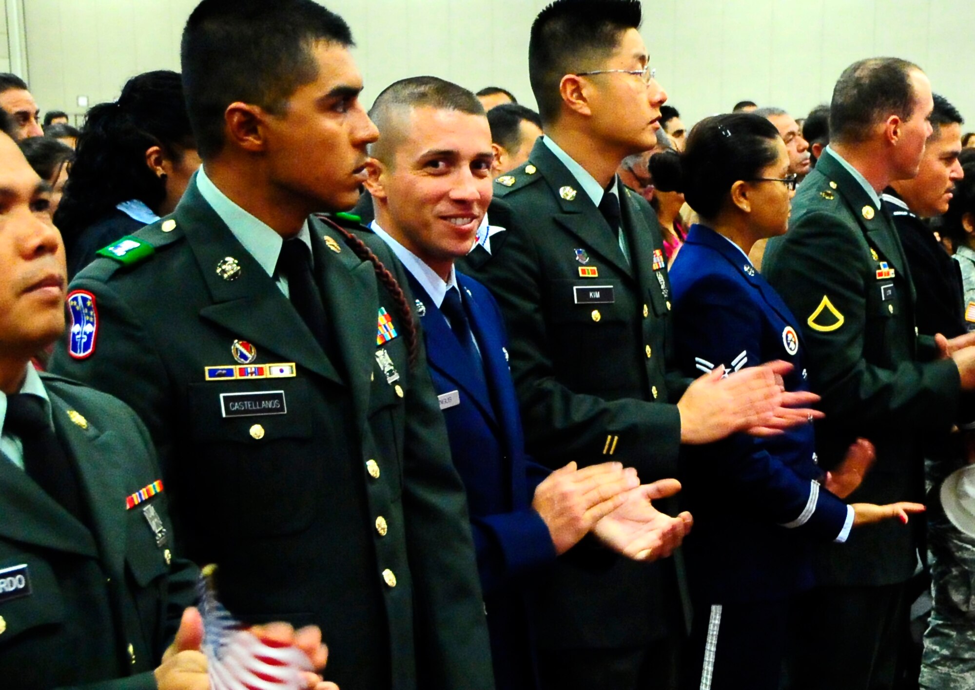 Airman 1st Class Alexandu Harangus, an electrical apprentice with the 49th Civil Engineers Squadron, flashes a smile as he completes the process to become a U. S. citizen March 11. A1C Harangus was among 1,000 applicants who received their citizenship at the El Paso Convention Center. (U.S. Air Force Photo/TSgt Chris Flahive