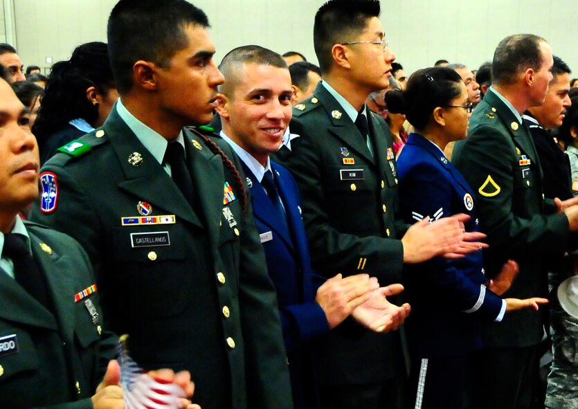 Airman 1st Class Alexandu Harangus, an electrical apprentice with the 49th Civil Engineers Squadron, flashes a smile as he completes the process to become a U. S. citizen March 11. A1C Harangus was among 1,000 applicants who received their citizenship at the El Paso Convention Center. (U.S. Air Force Photo/TSgt Chris Flahive