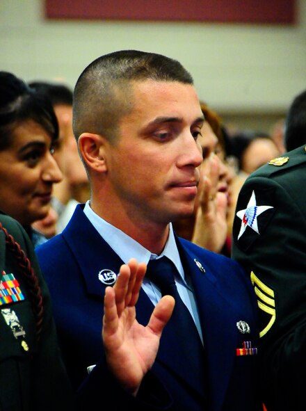 Airman 1st Class Alexandru Harangus takes the oath of citizenship at the El Paso Convention Center March 11. A1C Harangus moved to the United States from Romania in 2007. (U.S. Air Force Photo/TSgt Chris Flahive)