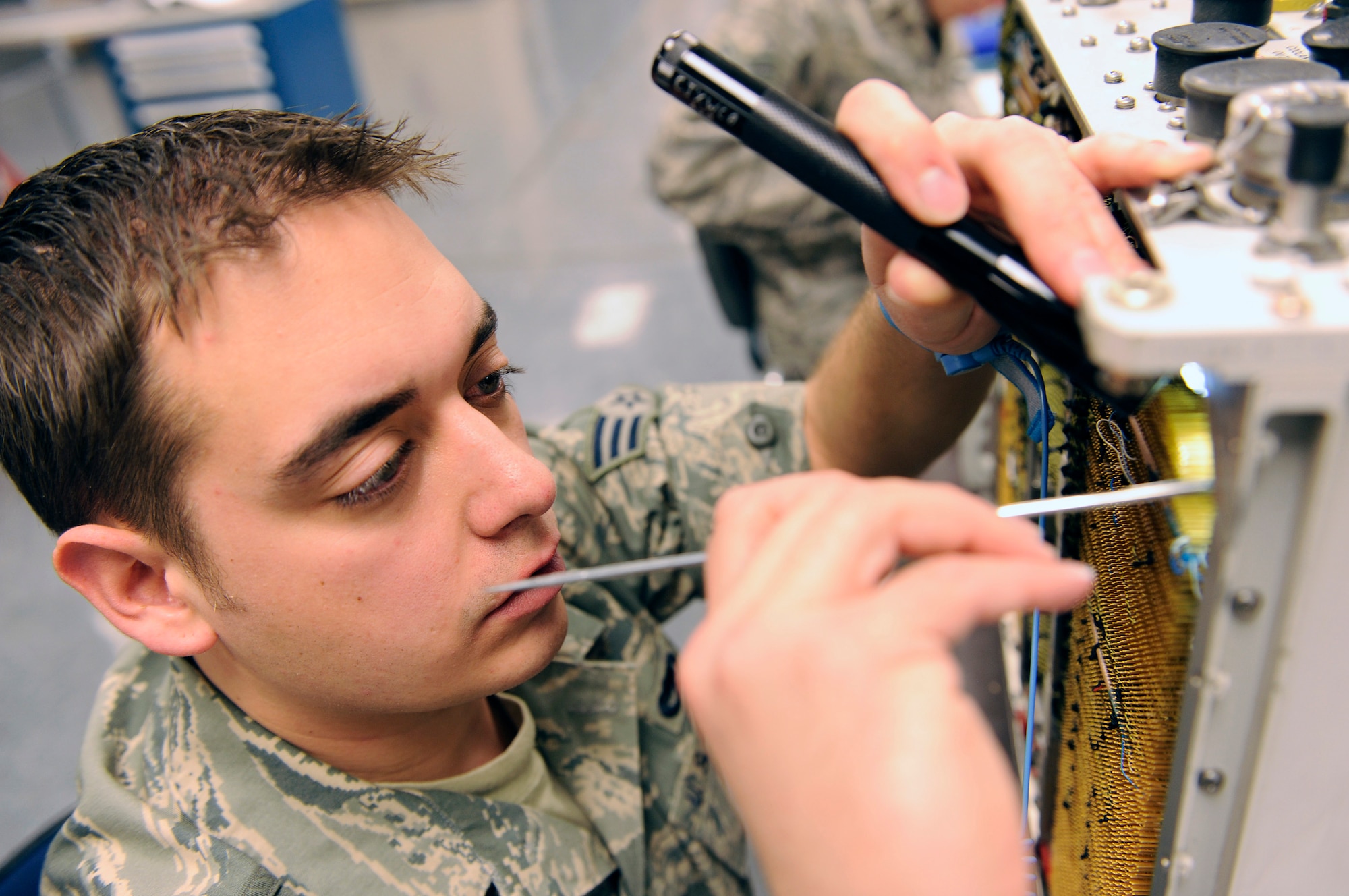 Senior Airman David Holland, 28th Maintenance Squadron avionics test systems journeyman, inspects a control interface unit for foreign objects, broken wires and coolant leaks at the 28th Maintenance Squadron, March 18. Members of the 28 MXS provide intermediate-level maintenance for B-1B Lancer aircraft and F-101-GE-102 engines in the 28th Bomb Wing. (U.S. Air Force photo/Senior Airman Marc I. Lane)