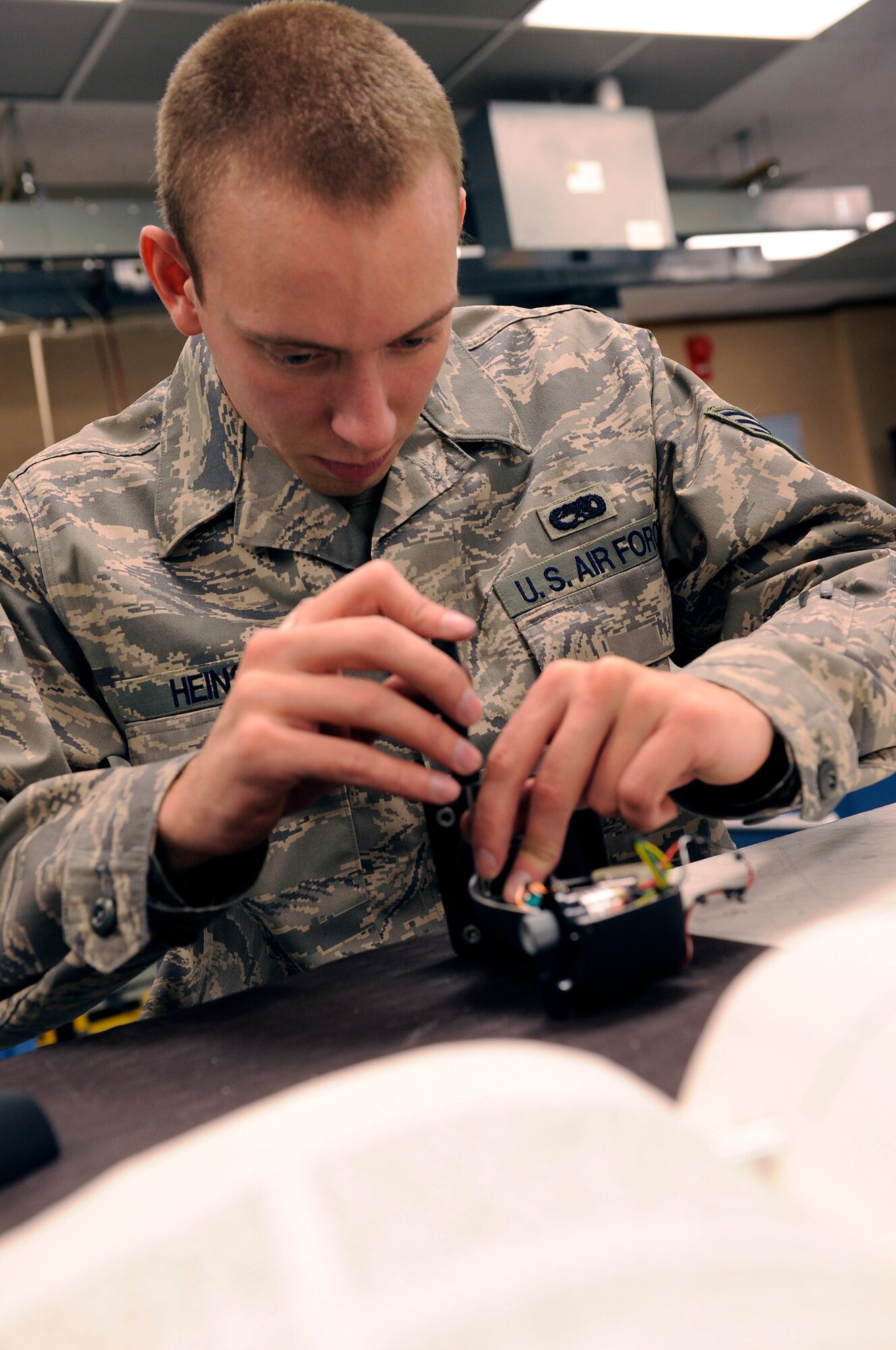 Senior Airman Philip Heins, 28th Maintenance Squadron avionics test systems journeyman, assembles a defensive and offensive system operator at the 28th Maintenance Squadron, March 18. Members of the 28 MXS perform periodic inspections of weapon systems to support local training and worldwide conventional and contingency missions. (U.S. Air Force photo/Senior Airman Marc I. Lane)