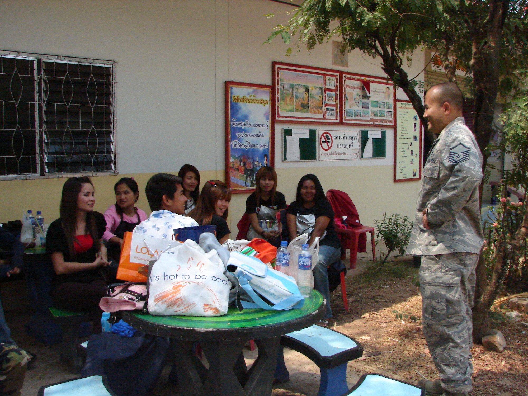 Master Sgt. Siamrad Maher pauses to speak with some local villagers
waiting at the Ban Pong Dang Namcha Samakkhi School near Korat, Thailand,
March 17.  The villagers attended a medical civic action outreach day
jointly hosted by U.S., Thai and Singaporean military personnel as part of
Cope Tiger 2009, an annual, multinational, large forces aerial exercise
which has aerial and humanitarian outreach portions in and near both Korat
and Udon Thani, Thailand.  Sergeant Maher was born in Nong Pai Lom, a
village nearby.
