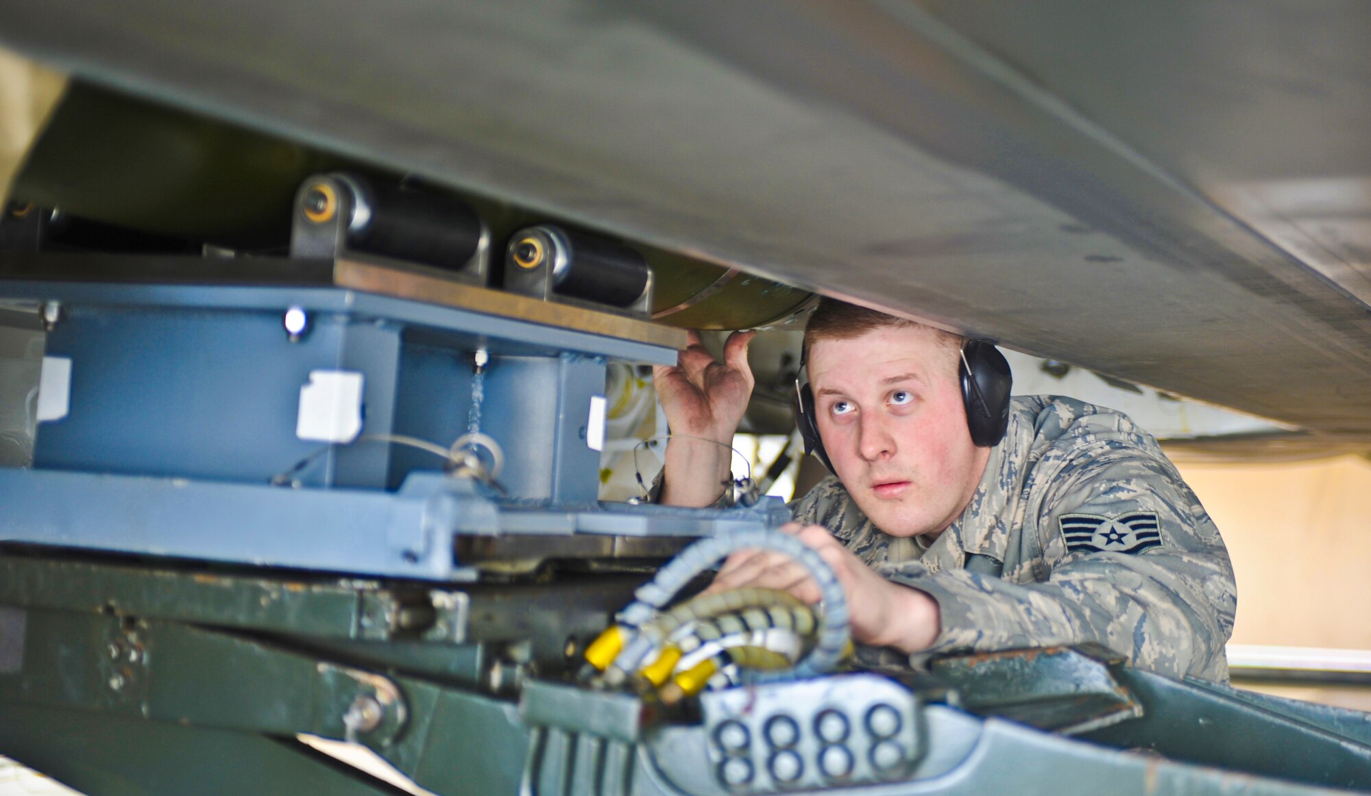 ELMENDORF AIR FORCE BASE, Alaska -- Staff Sgt. Jason Leighton, 90th Aircraft Maintenance Unit, examines a bomb being loaded onto a F-22 during a load crew inspection March 11, 2009. Leighton is a 2009 Lt. Gen. Leo Marquez Award winner in the Munitions/Missile Technician Supervisor Category. The Marquez Award is one of the hightest honors for a maintainer at Air Force level. (U.S. Air Force photo/Senior Airman Matthew Owens)