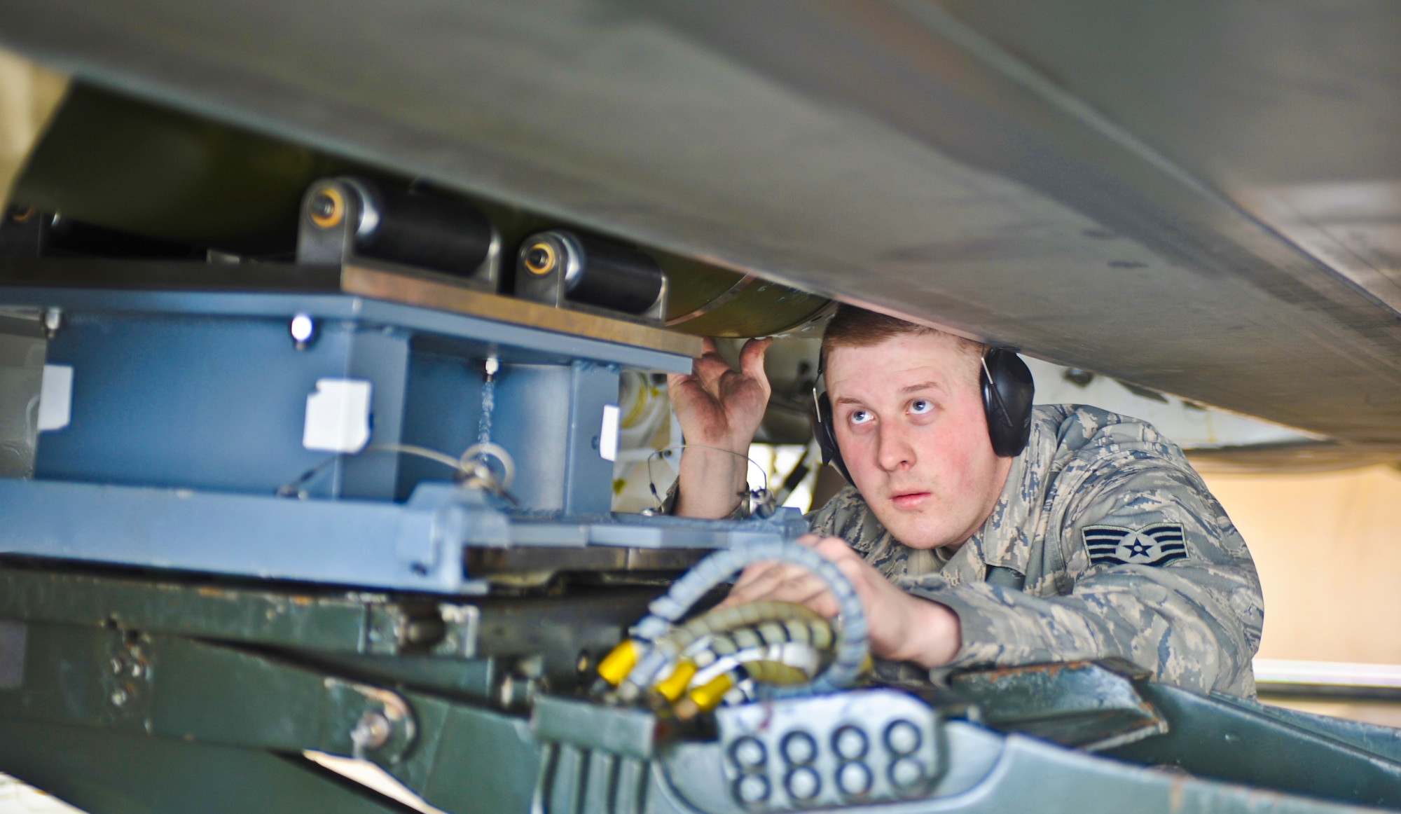 ELMENDORF AIR FORCE BASE, Alaska -- Staff Sgt. Jason Leighton, 90th Aircraft Maintenance Unit, examines a bomb being loaded onto a F-22 during a load crew inspection March 11, 2009. Leighton is a 2009 Lt. Gen. Leo Marquez Award winner in the Munitions/Missile Technician Supervisor Category. The Marquez Award is one of the hightest honors for a maintainer at Air Force level. (U.S. Air Force photo/Senior Airman Matthew Owens)