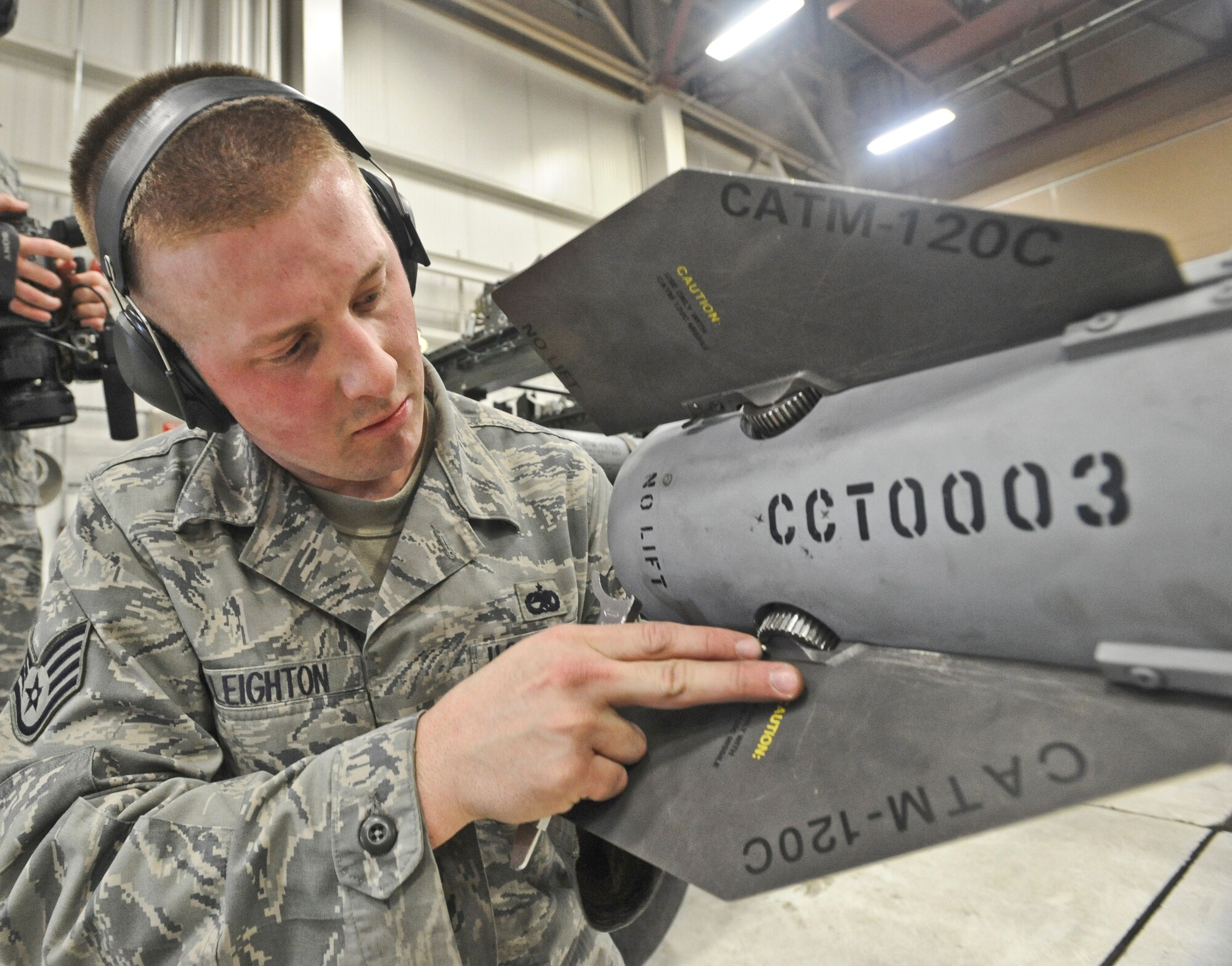 ELMENDORF AIR FORCE BASE, Alaska -- Staff Sgt. Jason Leighton, 90th Aircraft Maintenance Unit, examines a missile before loading it with his crew onto a F-22 during a load crew inspection March 11, 2009. Leighton is a 2009 Lt. Gen. Leo Marquez Award winner in the Munitions/Missile Technician Supervisor Category. The Marquez Award is one of the hightest honors for a maintainer at Air Force level. (U.S. Air Force photo/Senior Airman Matthew Owens)