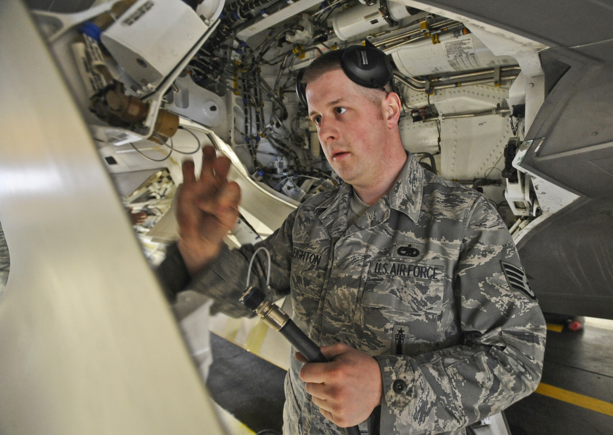 ELMENDORF AIR FORCE BASE, Alaska -- Staff Sgt. Jason Leighton, 90th Aircraft Maintenance Unit, examines the interior of a F-22 during a load crew inspection March 11, 2009. Leighton is a 2009 Lt. Gen. Leo Marquez Award winner in the Munitions/Missile Technician Supervisor Category. The Marquez Award is one of the hightest honors for a maintainer at Air Force level. (U.S. Air Force photo/Senior Airman Matthew Owens)