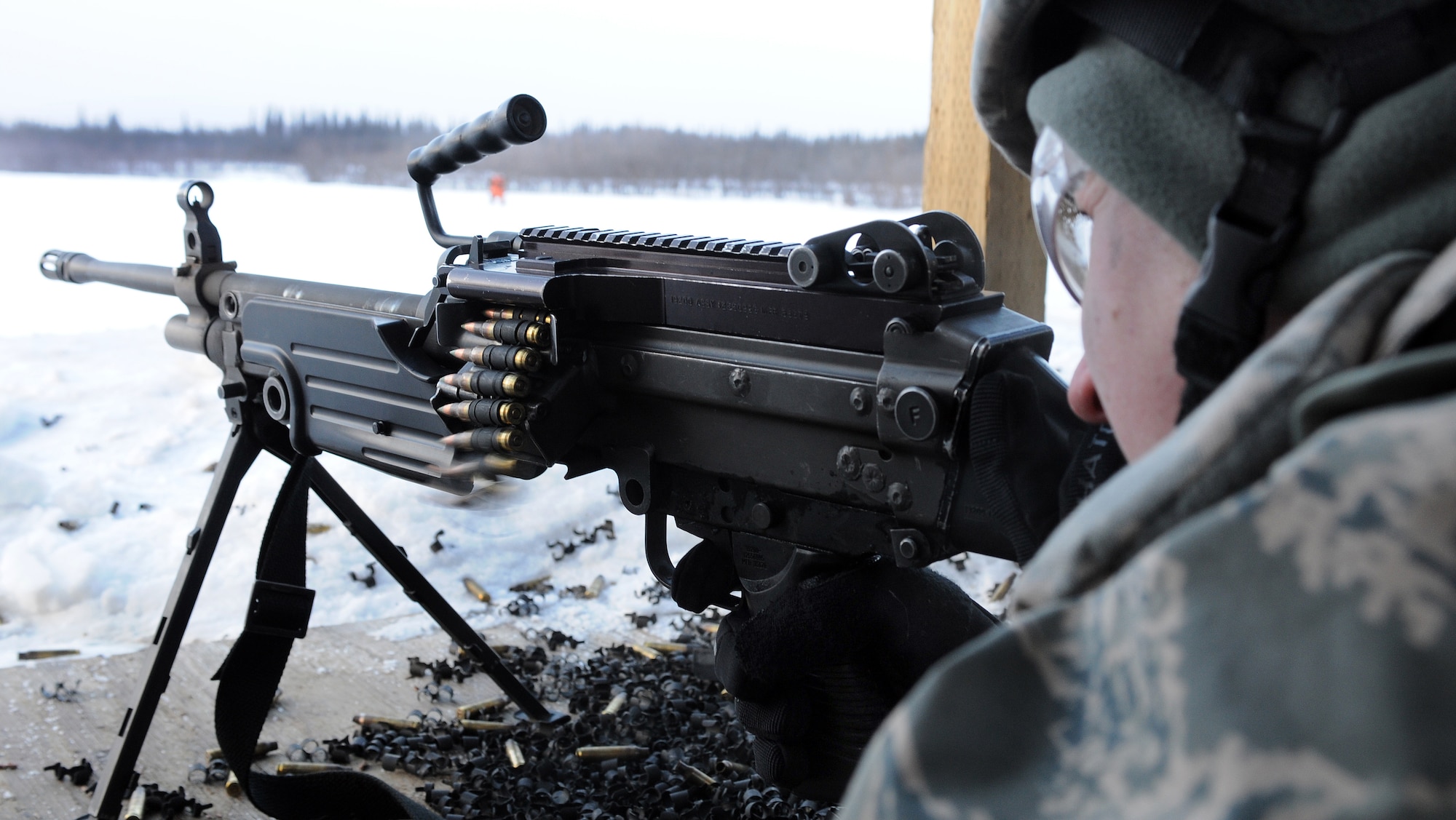 An Airman from the 354th Security Forces Squadron fires an M249 automatic rifle during a qualification course March 13, 2009, Eielson Air Force Base, Alaska. The M249 is capable of fully automatic fire, although eight to ten round burst fire is more frequently used. (U.S. Air Force photo/Airman 1st Class Willard E. Grande II)