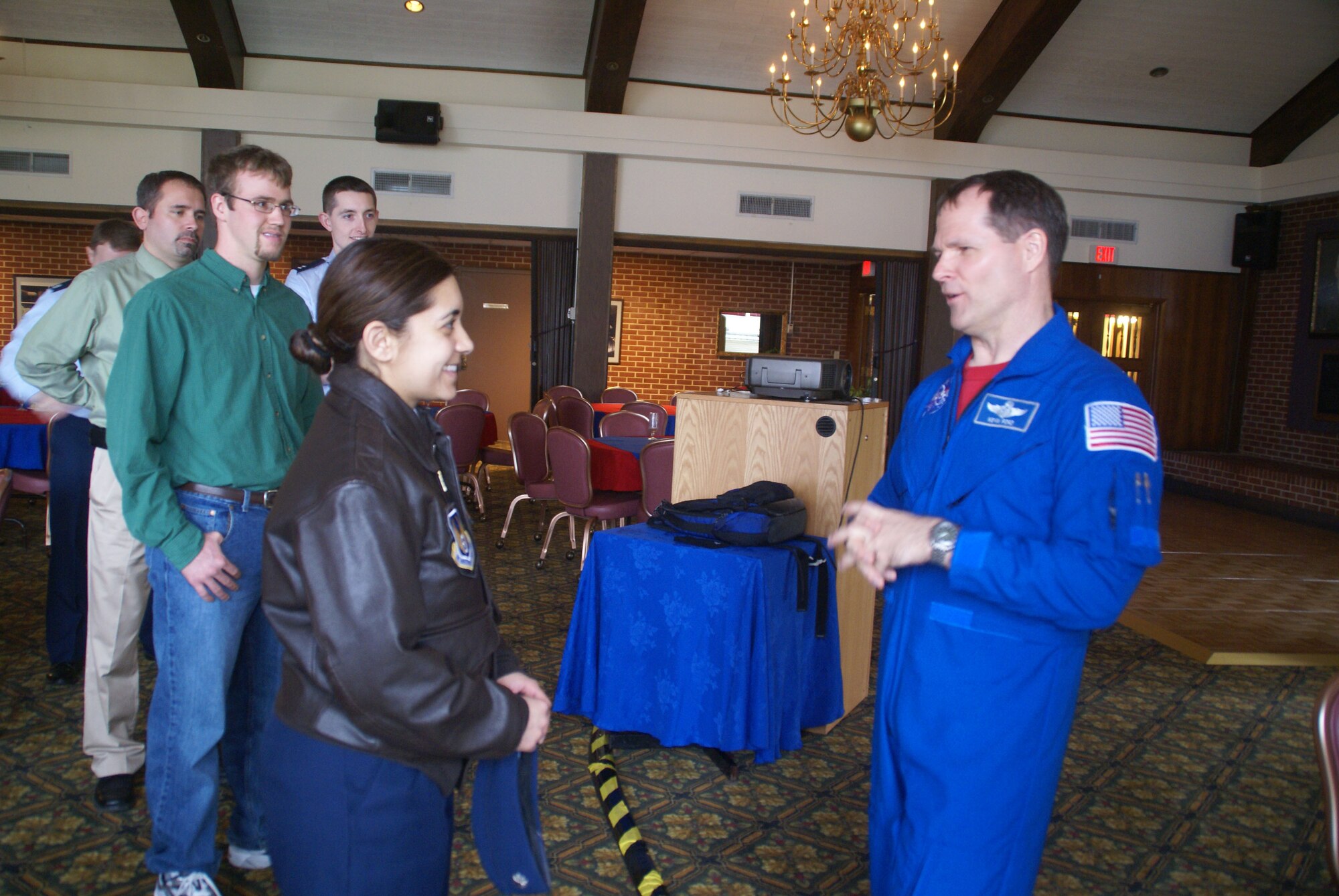 Dr. Kevin Ford, NASA space shuttle astronaut, answers questions posed by Lt. Col. Vanessa Bond, commander of Arnold Engineering Development Center's (AEDC) 716th Test Squadron, who knew him when she was a student at the U.S. Air Force Test Pilot School. From left, Capt. Jeff Hartberger, 649th Test Systems Squadron, Jeff Staines, AEDC's space and missiles test facility planning lead, Trey Zarecor, a sophomore at Auburn University, Ala., and Capt. Chuck McNiel, an aeropropulsion test technology lead at AEDC, wait for a chance to meet Dr. Ford. Besides emphasizing the need to continually advance one's formal education, Dr. Ford also said NASA would more seriously consider those candidates for the astronaut corps who have gained some operational experience and expertise, whether as a pilot or in some other technically-oriented capacity. He said those chosen for the astronaut corps among his group included one person who had served aboard Navy submarines, an oceanographer, a medical doctor and physicists. (Photo by Philip Lorenz III)