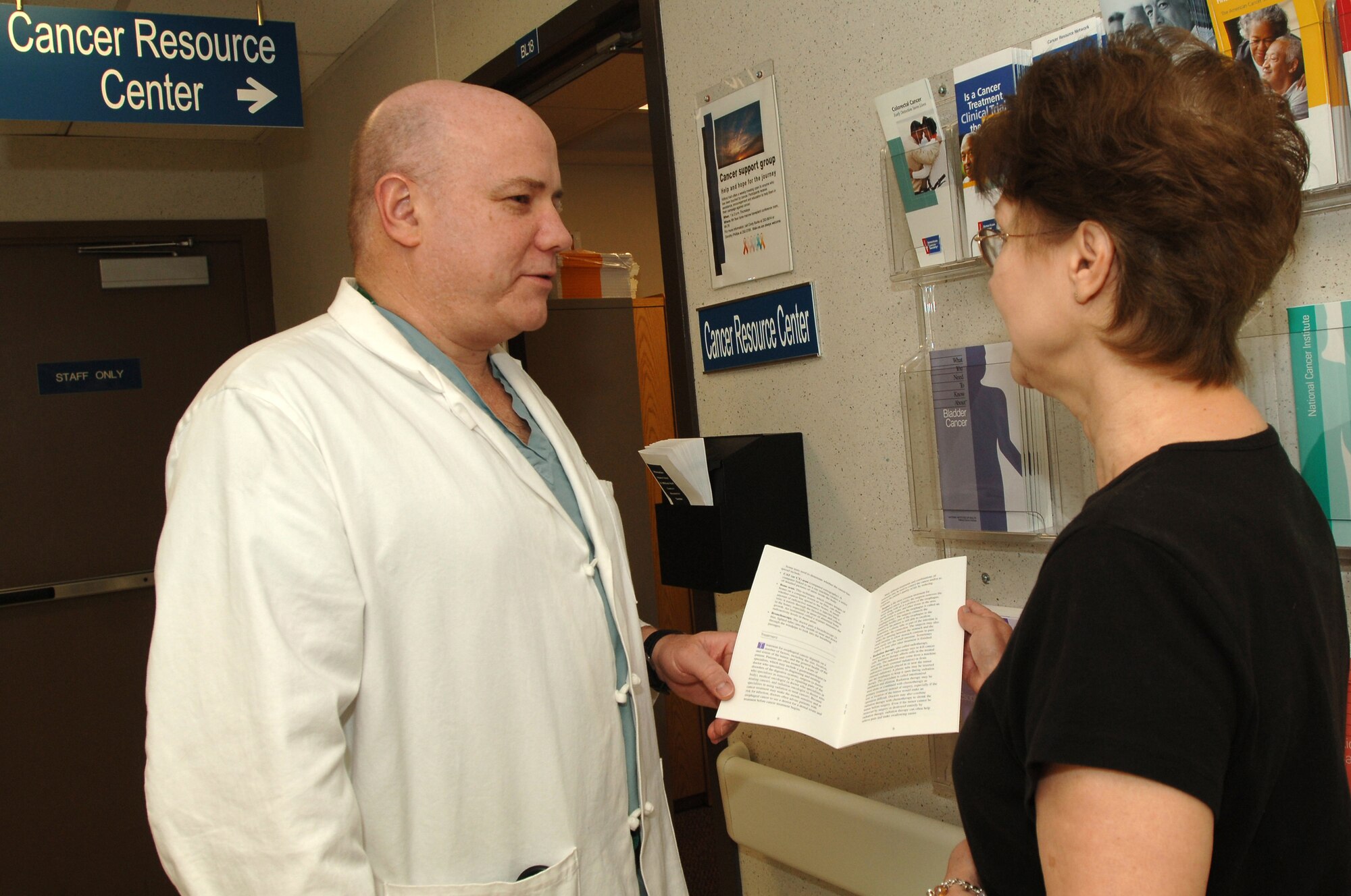 Department of Surgery chairman Col. (Dr.) David Smith (left) and registered nurse Dorothy Phillips discuss informational brochures at the Cancer Resource Center, Wilford Hall Medical Center, Lackland Air Force Base, Texas, on March 19. The new center is scheduled to open on March 31 and will provide educational resources for cancer patients.  (Air Force photo by Senior Airman Nicole Roberts)  
