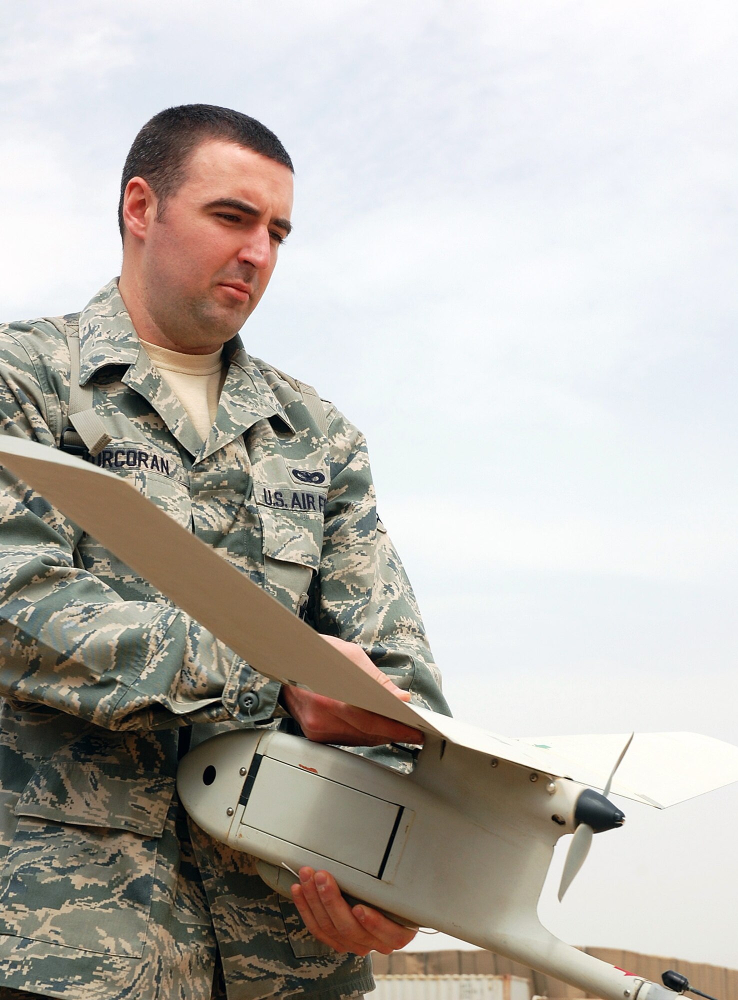 Airman 1st Class Shane Corcoran holds an RQ-11B unmanned aircraft system during preflight checks Feb. 25. Airman Corcoran is an 887th Expeditionary Security Forces Squadron Raven B operator in Iraq. (U.S. Air Force photo/Staff Sgt. Thomas J. Doscher) 