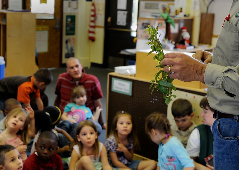 MOODY AIR FORCE BASE, Ga. -- John Crain, 23rd Civil Engineer Squadron base forester, explains the importance of Arbor Day to children enrolled in the pre-kindergarten class at the Child Development Center here March 19. Mr. Crain taught the children that trees are a living part of our environment and many of our household products are made from trees. (U.S. Air Force photo by Senior Airman Brittany Barker)