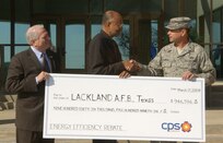 3/17/2009 - CPS Energy representatives John Saenz and Milton Lee present Brig. Gen. Len. Patrick, 37th Training Wing commander, with a rebate check March 17. The rebate is the largest ever awarded by CPS Energy and will be credited toward next month's bill. (USAF photo by Alan Boedeker)                  