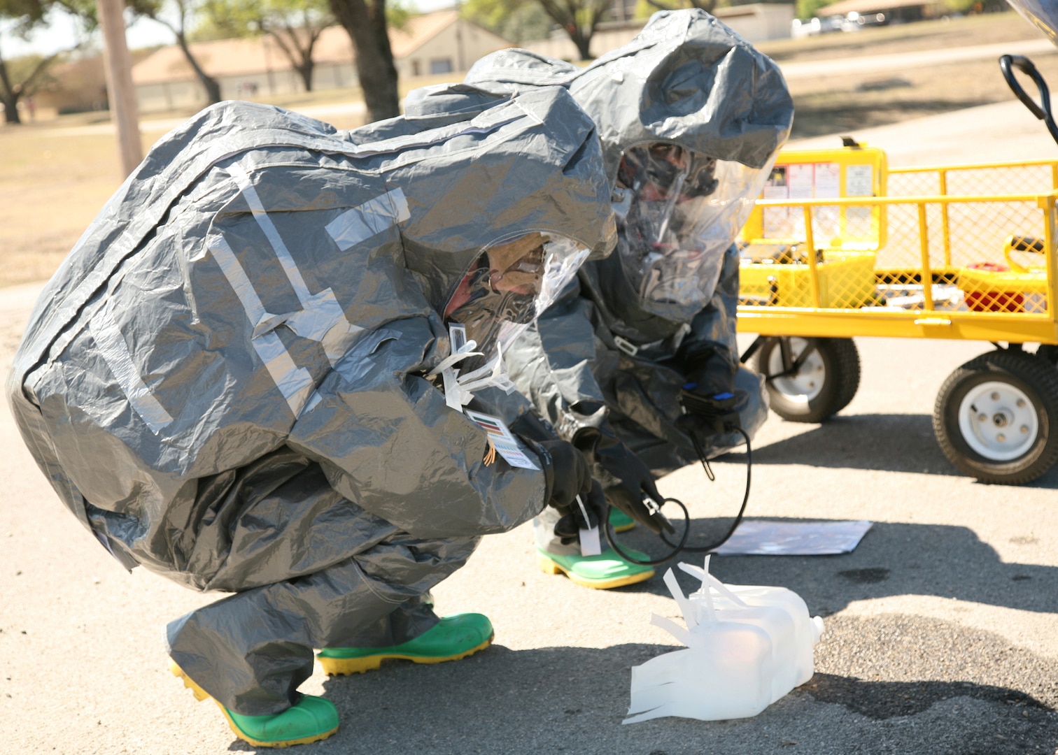 Staff Sgt. Shaun O'Dell (left) and Airman 1st Class Brandon Ruebsamen use a Drager Civil Defense Simultest Kit to perform sampling for a simulated suspected chemical warfare agent during a major accident response exercise March 16. The training exercise tested the 37th Training Wing and the 59th Medical Wing on their ability to respond to a major incident. Sergeant O'Dell and Airman Ruebsamen are both with the 37th Aerospace Medicine Squadron, Bioenvironmental Engineering. (USAF photo by Robbin Cresswell)