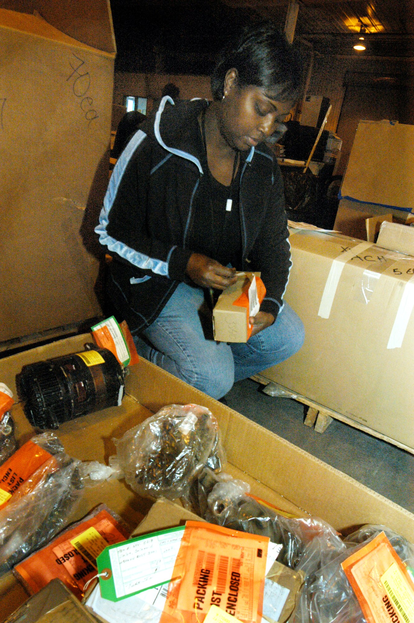 Leslie Capers, material examiner and identifier, puts labels on property for placement in inventory. A more efficient scheduling system allows customers to make appointments for turning in unneeded equipment to the DRMO. U. S. Air Force file photo by Sue Sapp       