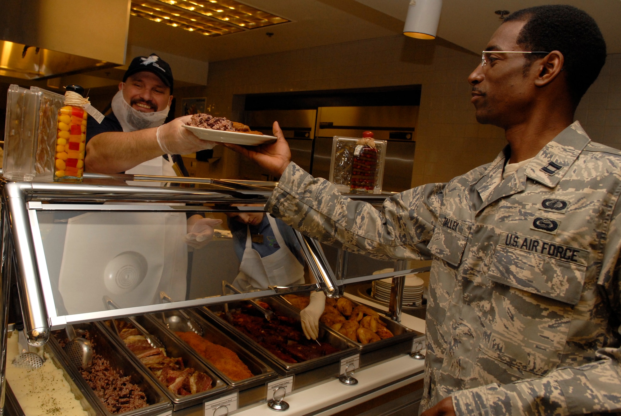 VANDENBERG AIR FORCE BASE, Calif. -- Chris Snooks, a food service worker at Breakers Dining Facility, serves Capt. Edward Talley, 392nd Training Squadron, a hot meal March 18. The facility is responsible for providing the nutrition Airmen need to perform their duties by being both healthy and affordable. (U.S. Air Force photo/Senior Airman Christian Thomas)

