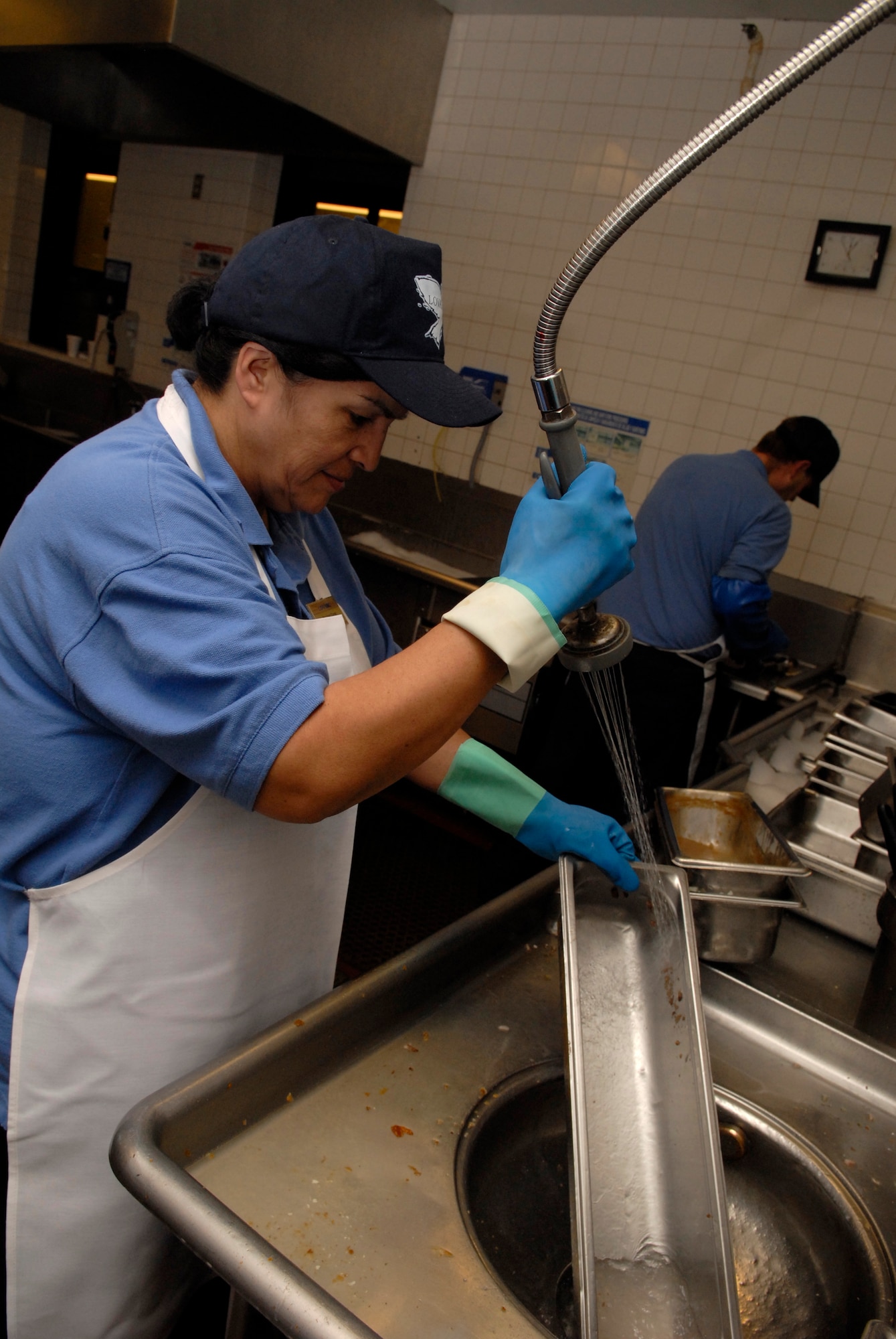 VANDENBERG AIR FORCE BASE, Calif. -- MaryAnn Canas, a food service worker at Breakers Dining Facility, cleans pots and pans March 18. The facility is responsible for providing the nutrition Airmen need to perform their duties by being both healthy and affordable. (U.S. Air Force photo/Senior Airman Christian Thomas)
