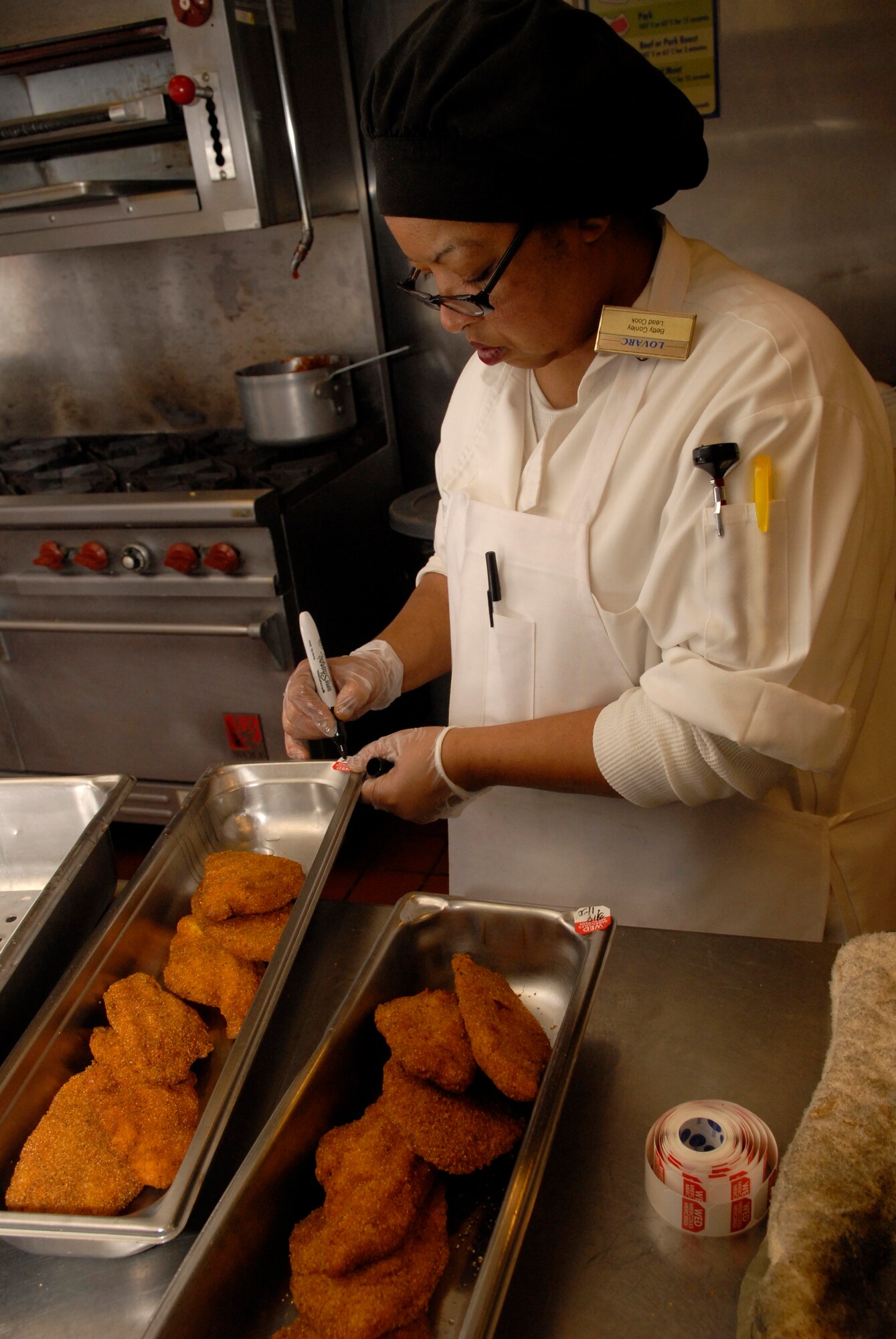 VANDENBERG AIR FORCE BASE, Calif. -- Betty Conley, a lead cook at Breakers Dining Facility, writes the date for when catfish was made March 18. The facility is responsible for providing the nutrition Airmen need to perform their duties by being both healthy and affordable. (U.S. Air Force photo/Senior Airman Christian Thomas)
