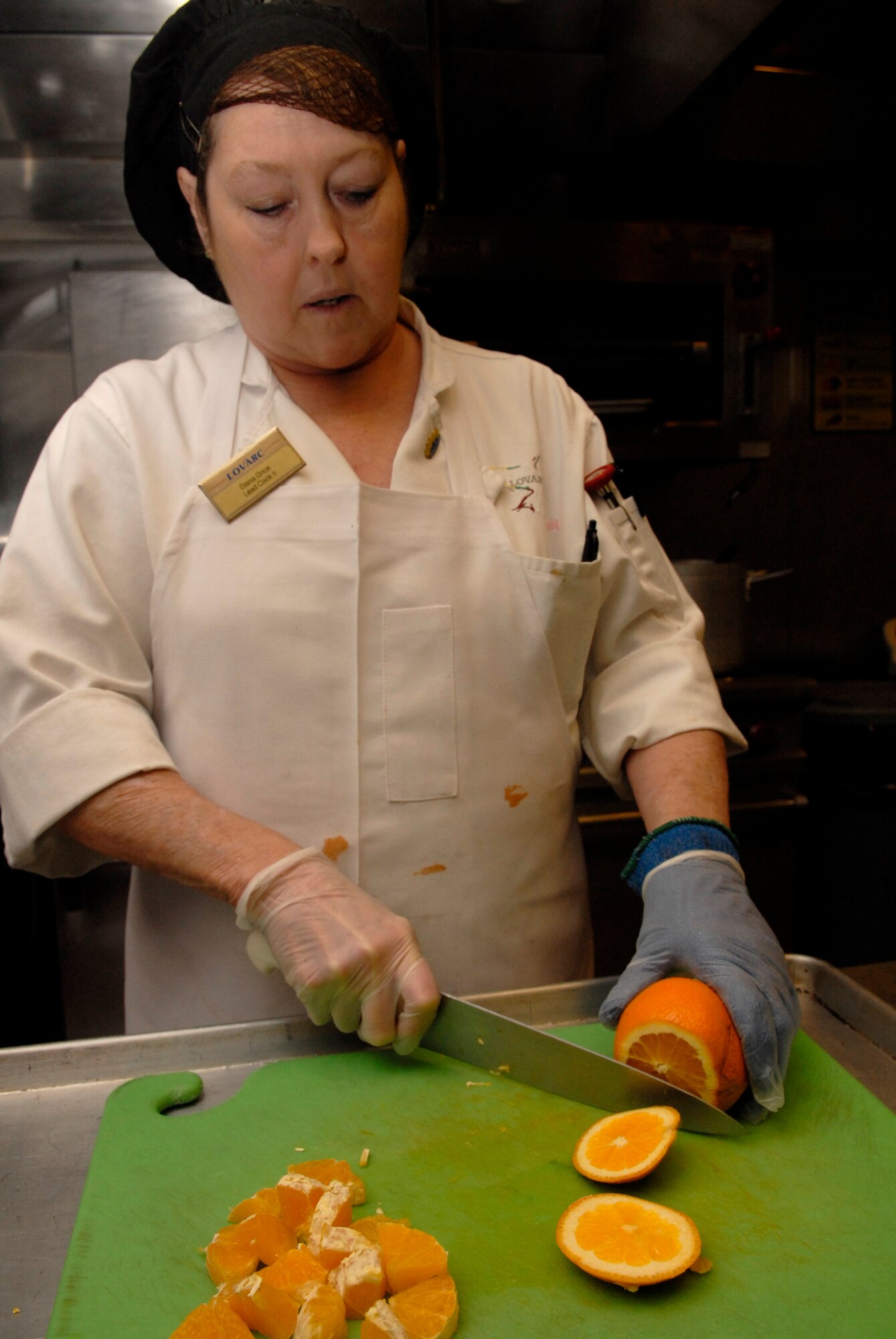 VANDENBERG AIR FORCE BASE, Calif. -- Diana Grice, a lead cook at Breakers Dining Facility, slices oranges to use in a recipe March 18. The facility is responsible for providing the nutrition Airmen need to perform their duties by being both healthy and affordable. (U.S. Air Force photo/Senior Airman Christian Thomas)
