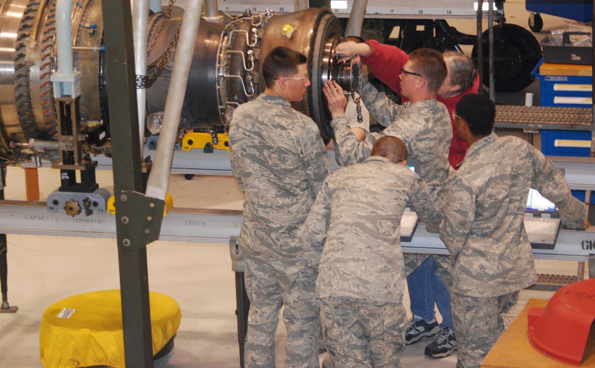A 361st Training Squadron Airmen-in-Training work on an engine during a training session March 13. (U.S. Air Force photo/Airman Adawn Kelsey)
