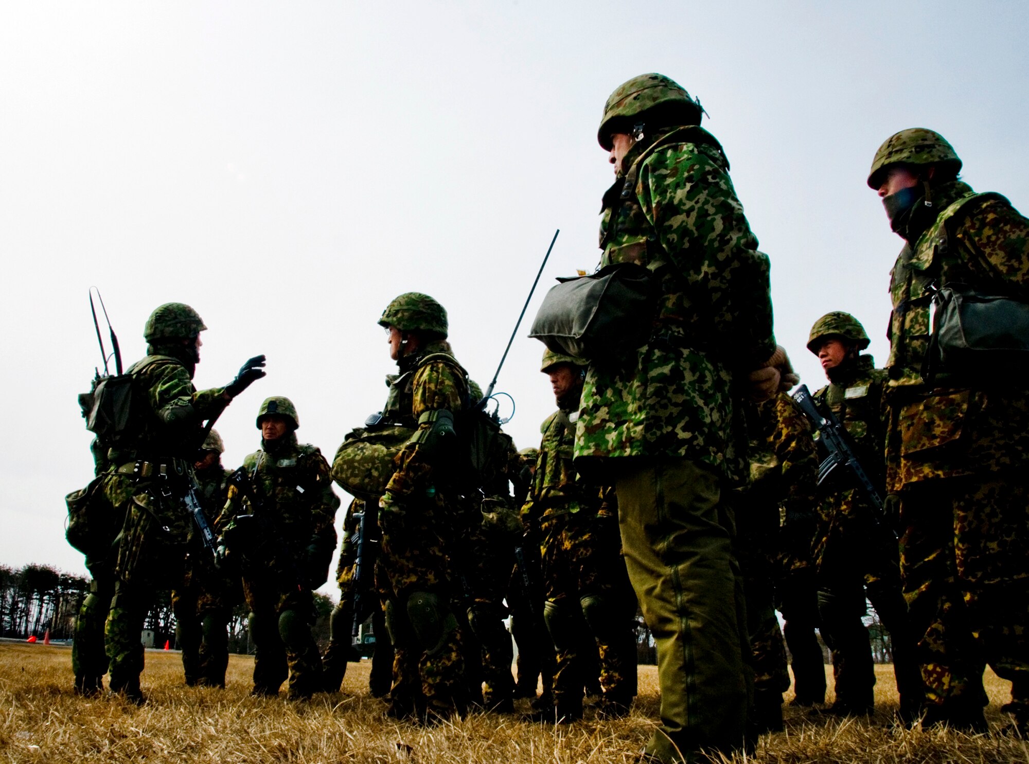 Members of the Japan Ground Self-Defense Force 9th Division, 5th Infantry Regiment, are debriefed after a successful Exercise Guard and Protect scenario March 13 at Misawa Air Base, Japan. The JGSDF troops were part of a 24-hour exercise that partnered them with the Japan Air Self-Defense Force 3rd Air Wing and the U.S. Air Force 35th Security Forces Squadron. (U.S. Air Force photo/Senior Airman Jamal D. Sutter) 
