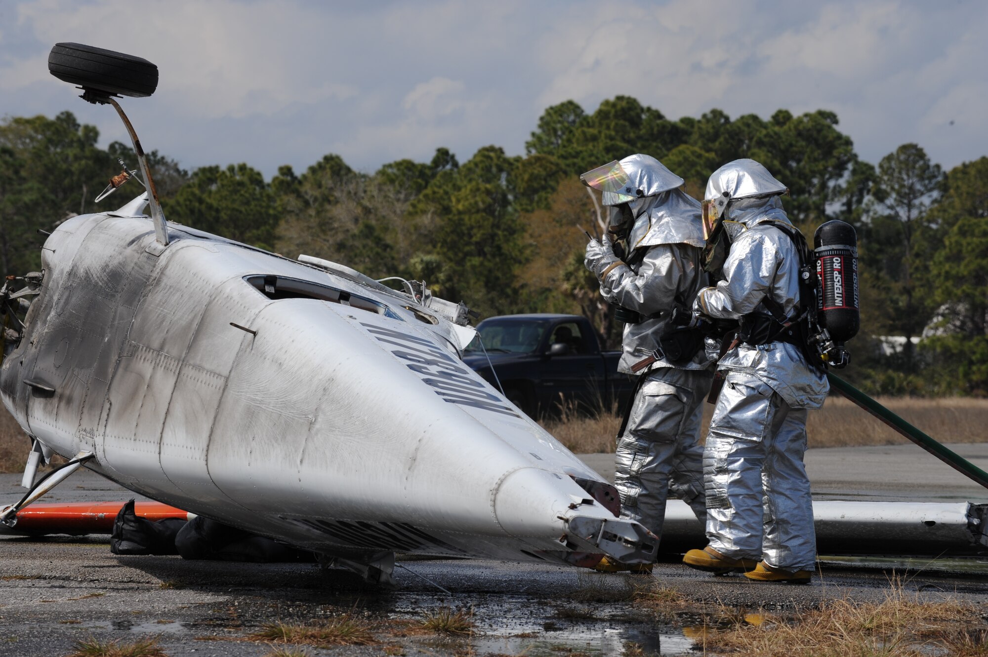Firefighters from the 45th Civil Engineer Squadron respond to the scene of a simulated plane crash at the Malabar Training Annex during the recent weeklong Operation Ocean Breeze deployment exercise. (U.S. Air Force photo/John Connell)