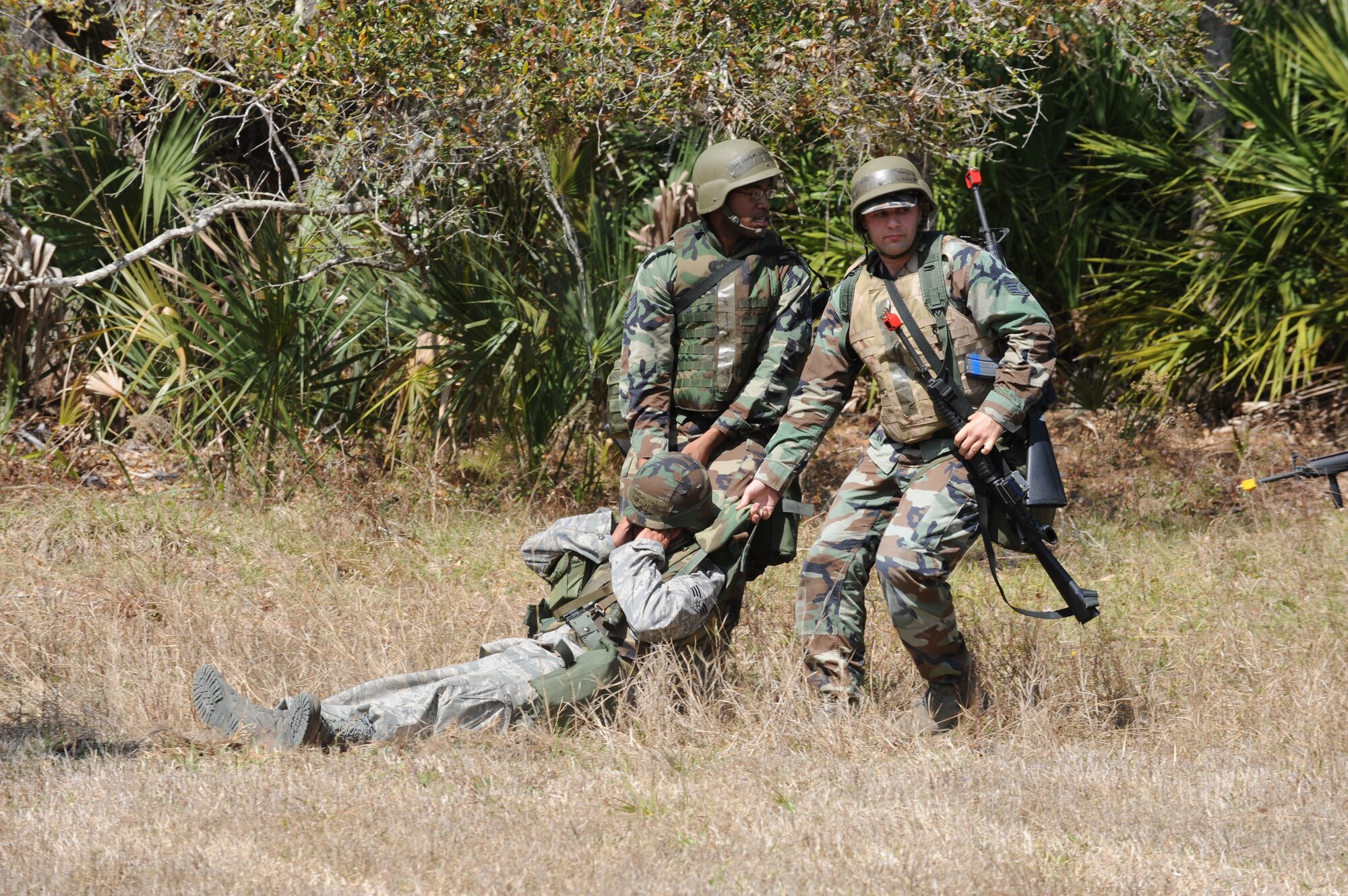 Airmen do the clothes pull to get a casualty to safety following a simulated attack at the Malabar Training Annex during the recent weeklong Operation Ocean Breeze deployment exercise. (U.S. Air Force photo/John Connell)