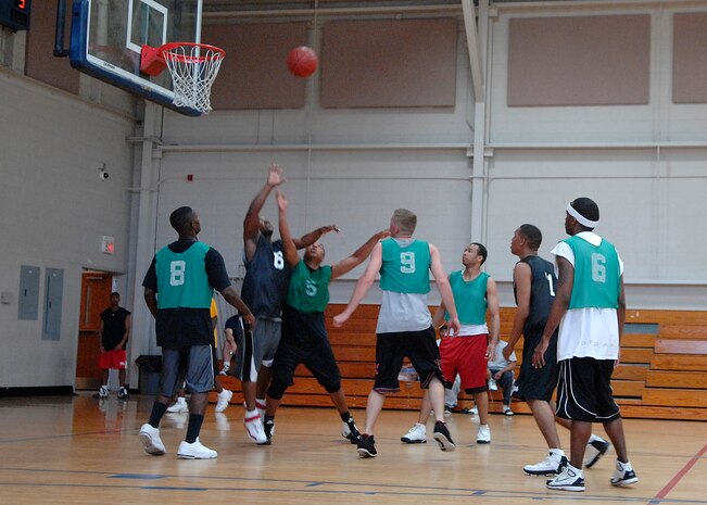 AMXS and SFS teams attempt to rebound the ball during the intramural basketball game at the Fitness and Sports Center here Mar. 18.  AMXS defeated the SFS team 50-46. (U.S. Air Force photo/Senior Airman Katie Gieratz)
