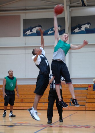 Yale Akers gains possession of the ball at the tip off of the intramural basketball game at the Fitness and Sports Center here Mar. 18. AMXS defeated the SFS team 50-46. Akers is with the 437th Aircraft Maintenance Squadron. (U.S. Air Force photo/Senior Airman Katie Gieratz)