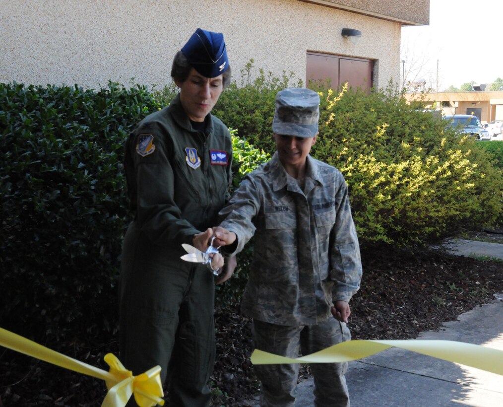 SEYMOUR JOHNSON AIR FORCE BASE, N.C. -- Col. Caroline Evernham (left), 916th Operations Group commander and Senior Airman Jessica Welch of the 911th Air Refueling Squadron, cut the ribbon on the refurbished 916th Aircrew Flight Equipment Facility. The redesigned building offers new office space and expanded areas for life support equipment. The ribbon cutting ceremony took place here on March 18.