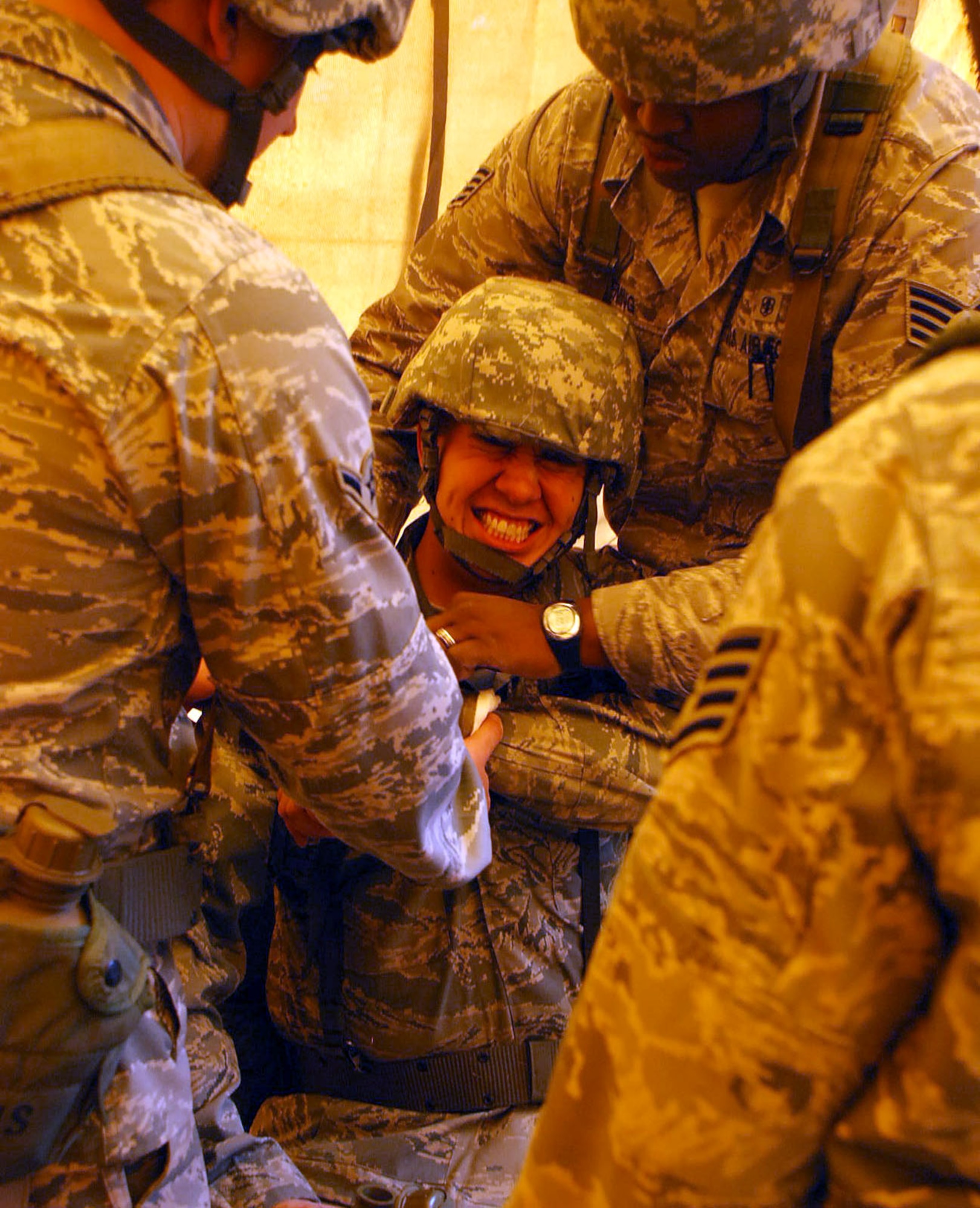 LAUGHLIN AIR FORCE BASE, Texas – Airman 1st Class Joseph Foderaro, 47th Medical Operations Squadron and exercise participant, receives medical attention after an artificial bullet wound to the shoulder during the Ability to Survive and Operate exercise here March 18. The ATSO exercise consisted of more than 50 Laughlin Airmen working together to sharpen their war-fighting skills by completing different scenarios they could possibly face in a deployed location. (U.S. Air Force photo by Airman 1st Class Sara Csurilla)