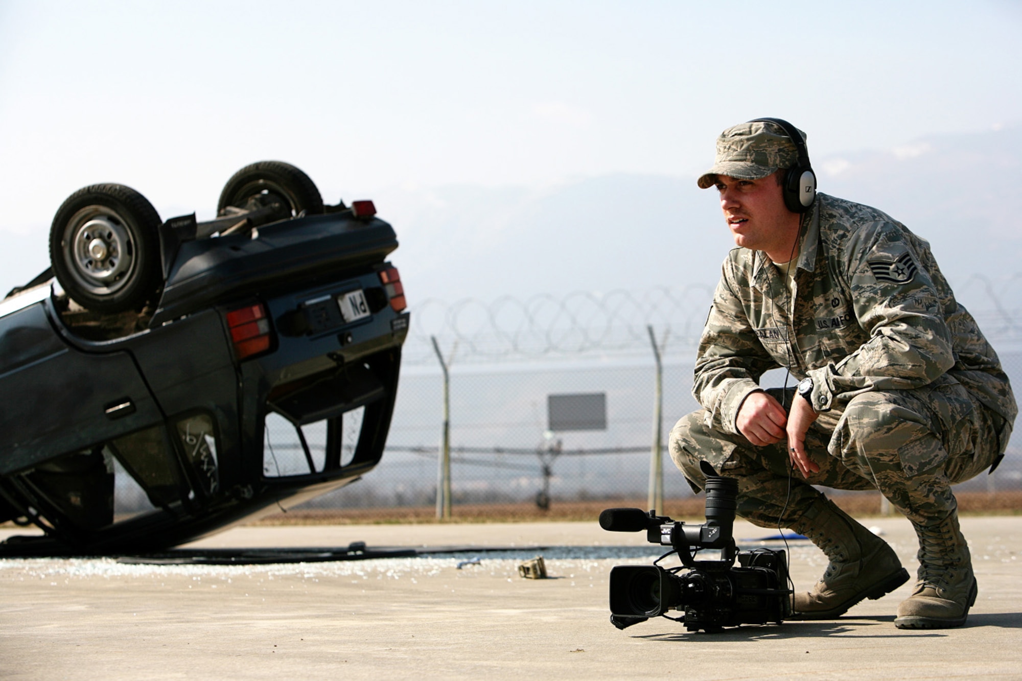 Staff Sgt. Todd Kabalan, a broadcast journalist assigned to American Forces Network Aviano, Defense Media Activity, documents a firefighter training session at Aviano Air Base, Italy,  March 18.  Staff Sgt. Kabalan  is one of five members of AFN Aviano who were recently recognized as among the best in Air Force broadcasting during the 2008 Air Force Media Contest. Sergeant Kabalan received first place in the Radio News Report and Television Newsbreak categories. (U.S. Air Force photo/Senior Master Sgt. Robert W. Valenca)    