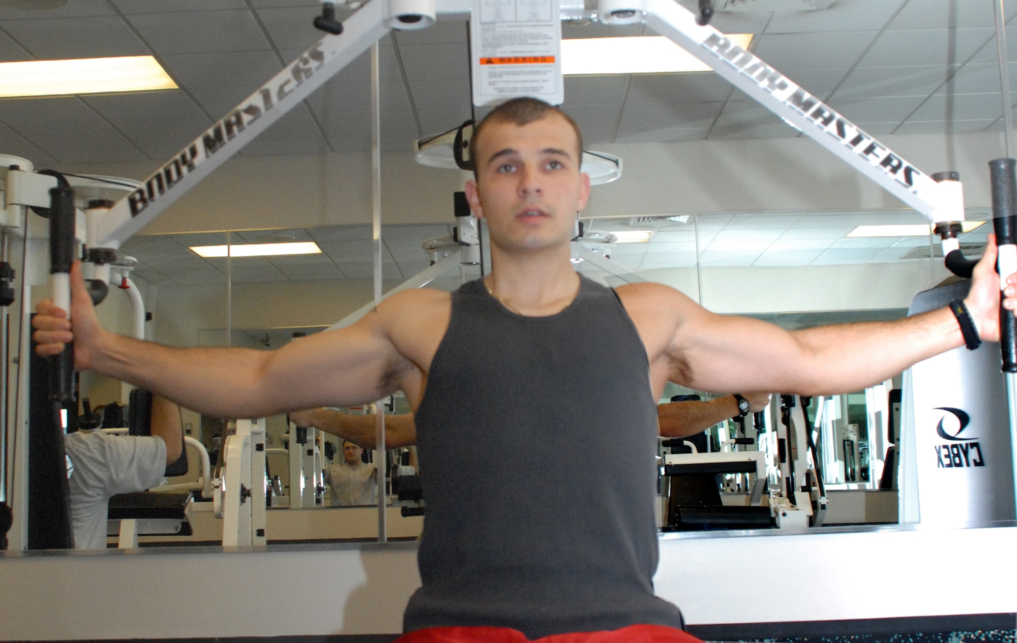 Senior Airman Alexandru Stoica, 436th Services Squadron, works out his upper body at the Dover Fitness Center.  Airman Stoica recently scored a perfect 100 on the PT test.  (U.S. Air Force photo/Staff Sgt. Chad Padgett)