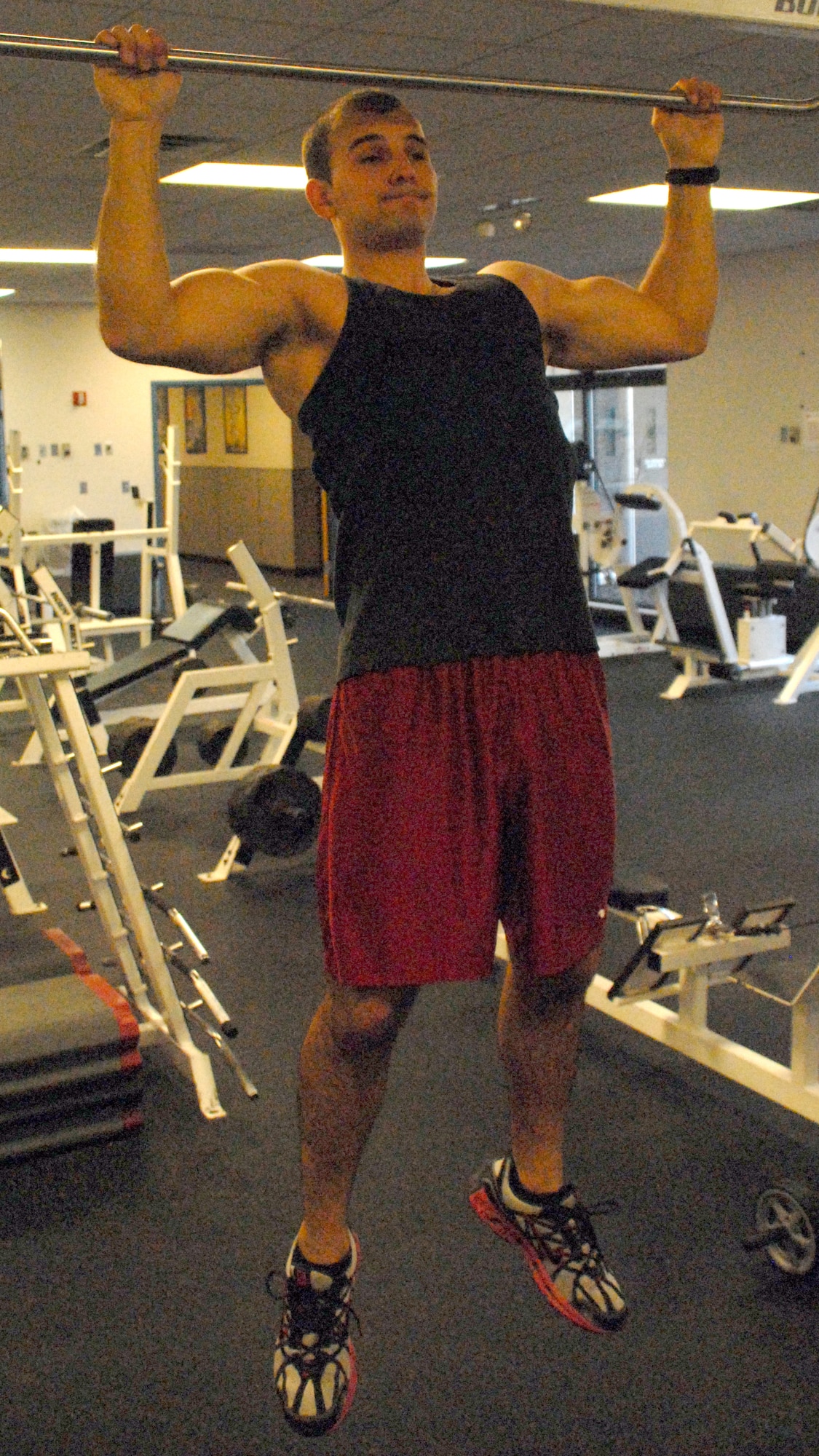 Senior Airman Alexandru Stoica, 436th Services Squadron, does pull ups at the Dover Fitness Center.  Airman Stoica recently scored a perfect 100 on the PT test.  (U.S. Air Force photo/Staff Sgt. Chad Padgett)