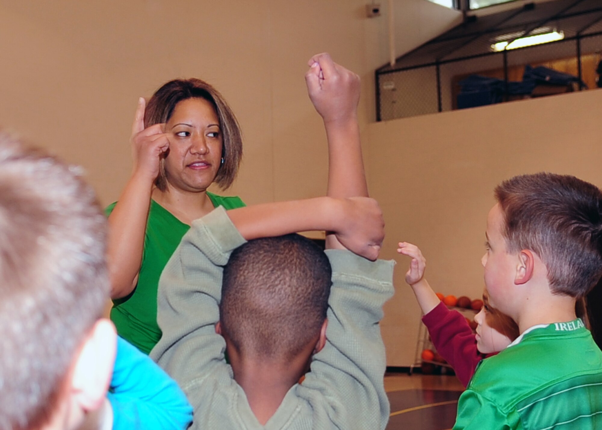 Natasha Fukushima, an after-school care provider at the base youth center, organizes a game of freeze tag at Seymour Johnson Air Force Base, N.C., March 17, 2009. Ms. Fukushima was recently nominated for the School-Age NOTES Foundation's Quest for Excellence Award. School-Age NOTES Foundation is a not-for-profit organization that supports after-school programs throughout the nation. (U.S. Air Force photo by Airman 1st Class Rae Perry)