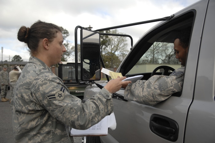 Airman 1st Class Ashley Scott gives the vehicle inspection sheet to Staff Sgt. Nicholas Hollis during the vehicle roll by inspection. The 437th Logistics Readiness Squadron conducted a vehicle roll by inspection for the upcoming Unit Compliance Inspection. Both Airman Scott and Sergeant Hollis are from the 437 LRS.