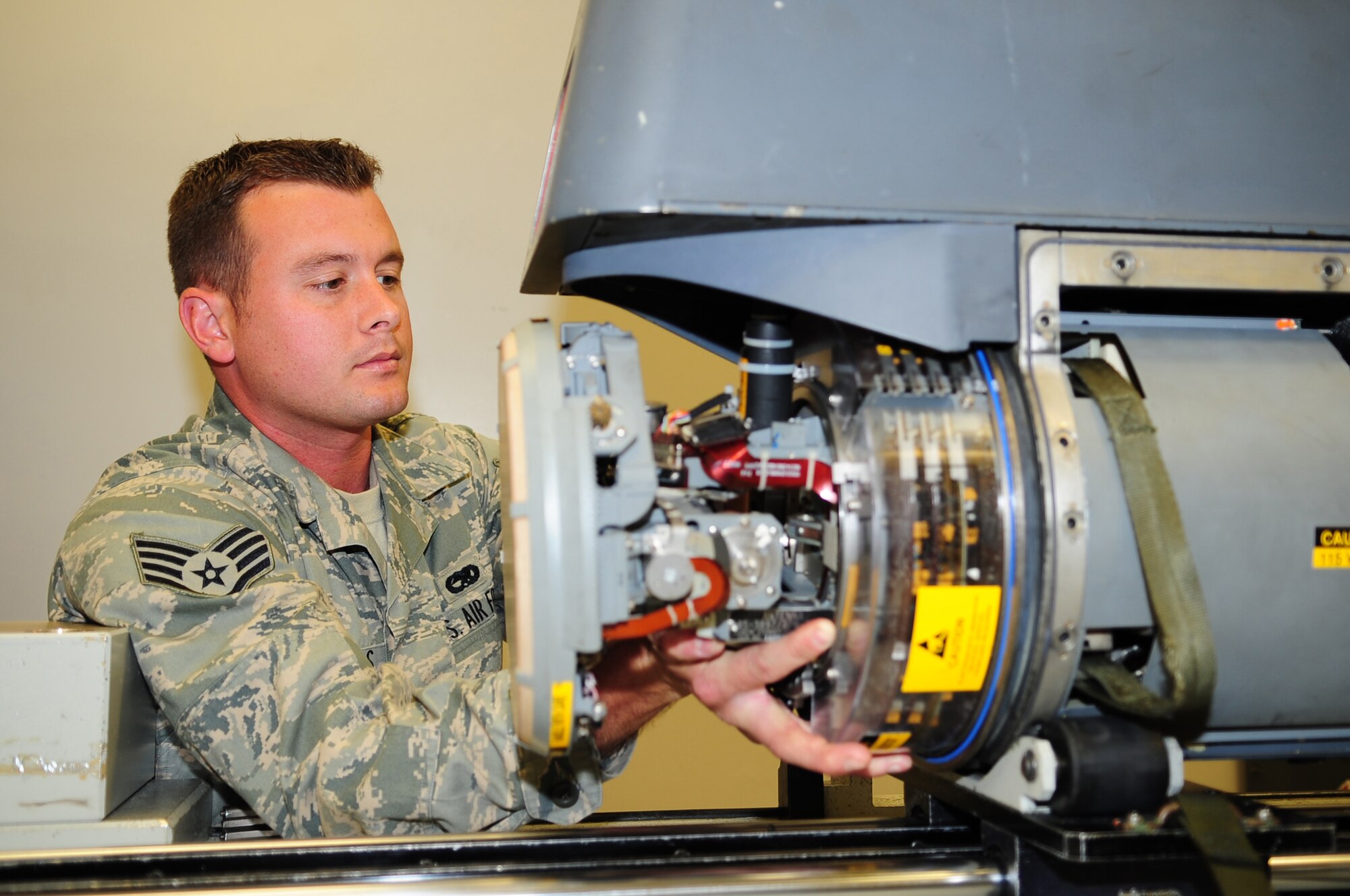 Staff Sgt. Christopher Woods, 4th Component Maintenance Squadron, reassembles a low-altitude-navigation-targeting-infrared-for-night navigation pod for an F-15E Strike Eagle at Seymour Johnson Air Force Base, N.C., March 10, 2009. Strike Eagles use navigation pods primarly for flying at night or in bad weather. (U.S. Air Force photo by Airman 1st Class Rae Perry)