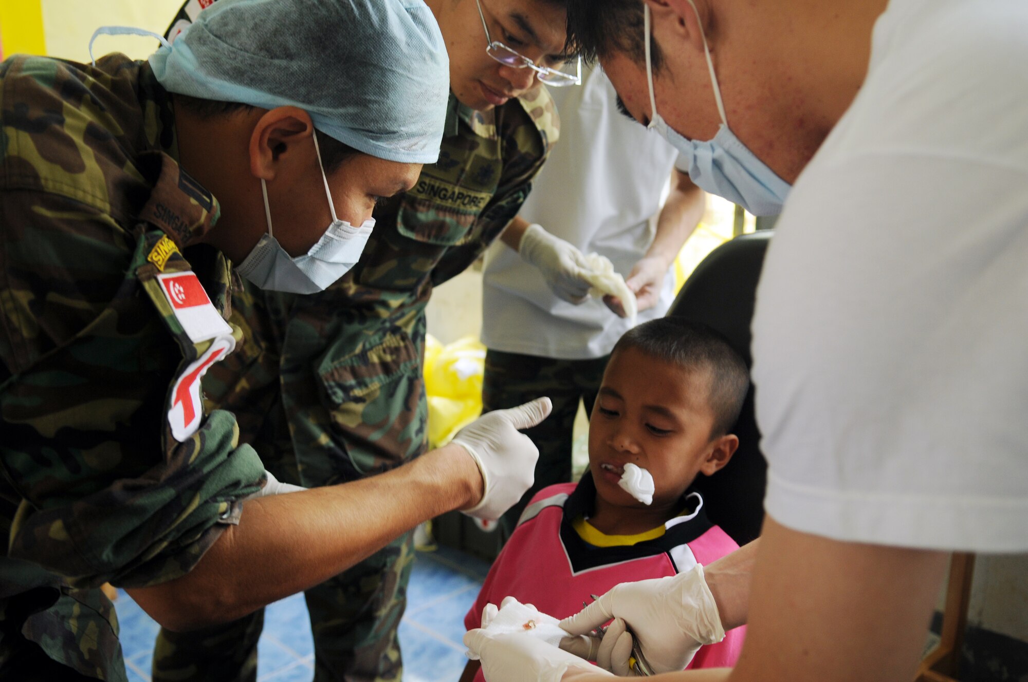 A team of Singaporean Dentists give a thumbs-up after performing a tooth extraction during a joint and multinational humanitarian mission to provide much needed dental care to Thailand's underprivileged during Cope Tiger 2009 on March 16.

Cope Tiger is an annual exercise held in Thailand to improve combat readiness and combined and joint interoperability of U.S., Thai and Singaporean forces while enhancing regional security and providing humanitarian support.
(U.S. Air Force Photo/Staff Sgt. Angelique Perez) 