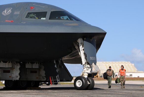 Airman 1st Class Joshua Silva, 36th Expeditionary Maintnenance Squadron crew chief, escorts a B-2 pilot during an engine running crew swap March 12 during exercise Polar Lightning.  Polar Lightning, flown out of Andersen Air Force Base, Guam,was designed to provide Bomber pilots experience in long duration missions.  B-2 Spirits are deployed here from Whiteman AFB, Mo. as part of a regularly scheduled Air Expeditionary Force rotation to the pacific.(U.S. Air Force photo by Senior Airman Ryan Whitney)
