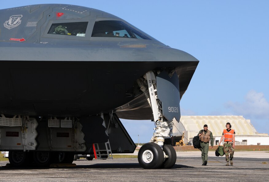 Airman 1st Class Joshua Silva, 36th Expeditionary Maintnenance Squadron crew chief, escorts a B-2 pilot during an engine running crew swap March 12 during exercise Polar Lightning.  Polar Lightning, flown out of Andersen Air Force Base, Guam,was designed to provide Bomber pilots experience in long duration missions.  B-2 Spirits are deployed here from Whiteman AFB, Mo. as part of a regularly scheduled Air Expeditionary Force rotation to the pacific.(U.S. Air Force photo by Senior Airman Ryan Whitney)