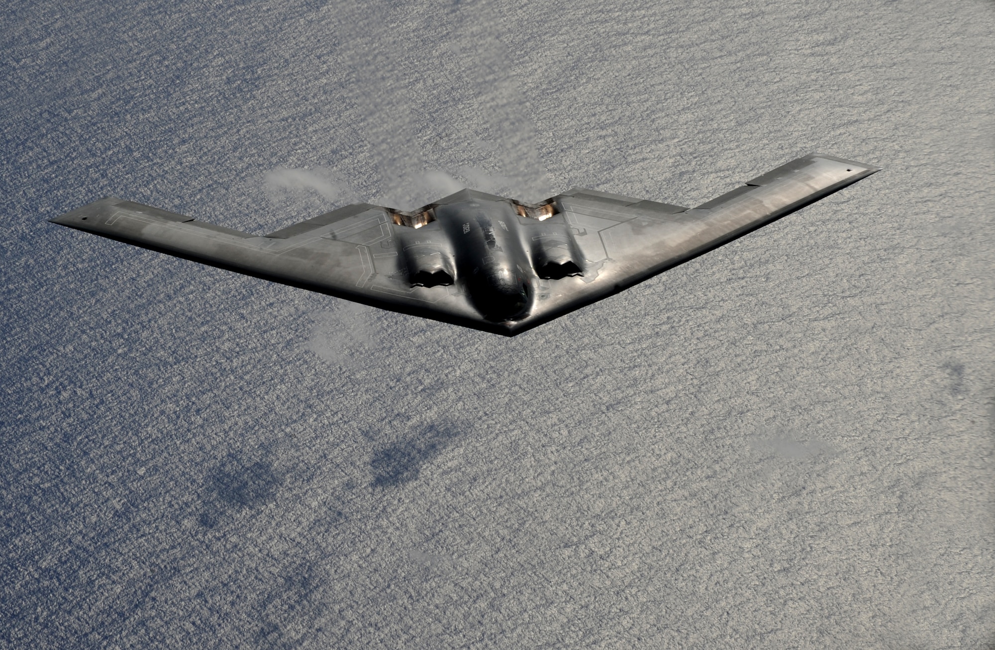 A B-2 Spirit from the 509th Bomb Wing, 13th Bomb Squadron Whiteman Air Force Base, Mo., flies over the Pacific Ocean during a mission exercise. The long-range, strategic bombers are part of the continuous rotating bomber presence deployed to Andersen Air Force Base, Guam. The rotating bomber units promote security and stability in the region as well as provide unique aircrew training opportunities.(U.S. Air Force photo/ Master Sgt. Kevin J. Gruenwald) released      