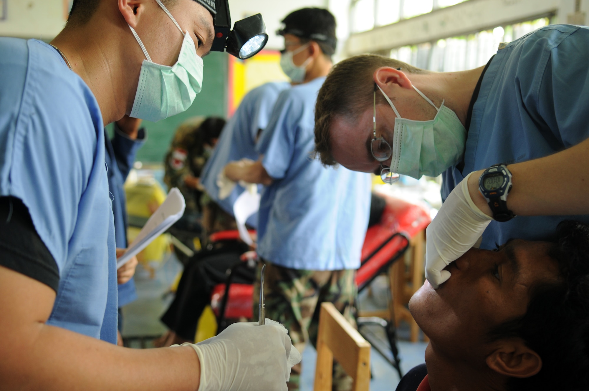 Staff Sgt. Scotty Scott (left), a Dental Technician from the 374th Dental Squadron, Yokota Air Base, Japan, assists Capt. Dana Jensen (right), a Dentist from the 18th Dental Squadron, Kadena Air Base, Japan, with a tooth extraction during a joint and multinational humanitarian mission to provide much needed dental care to Thailand's underprivileged during Cope Tiger 2009 on March 16.   

Cope Tiger is an annual exercise held in Thailand to improve combat readiness and combined and joint interoperability of U.S., Thai and Singaporean forces while enhancing regional security and providing humanitarian support.
(U.S. Air Force Photo/Staff Sgt. Angelique Perez) 