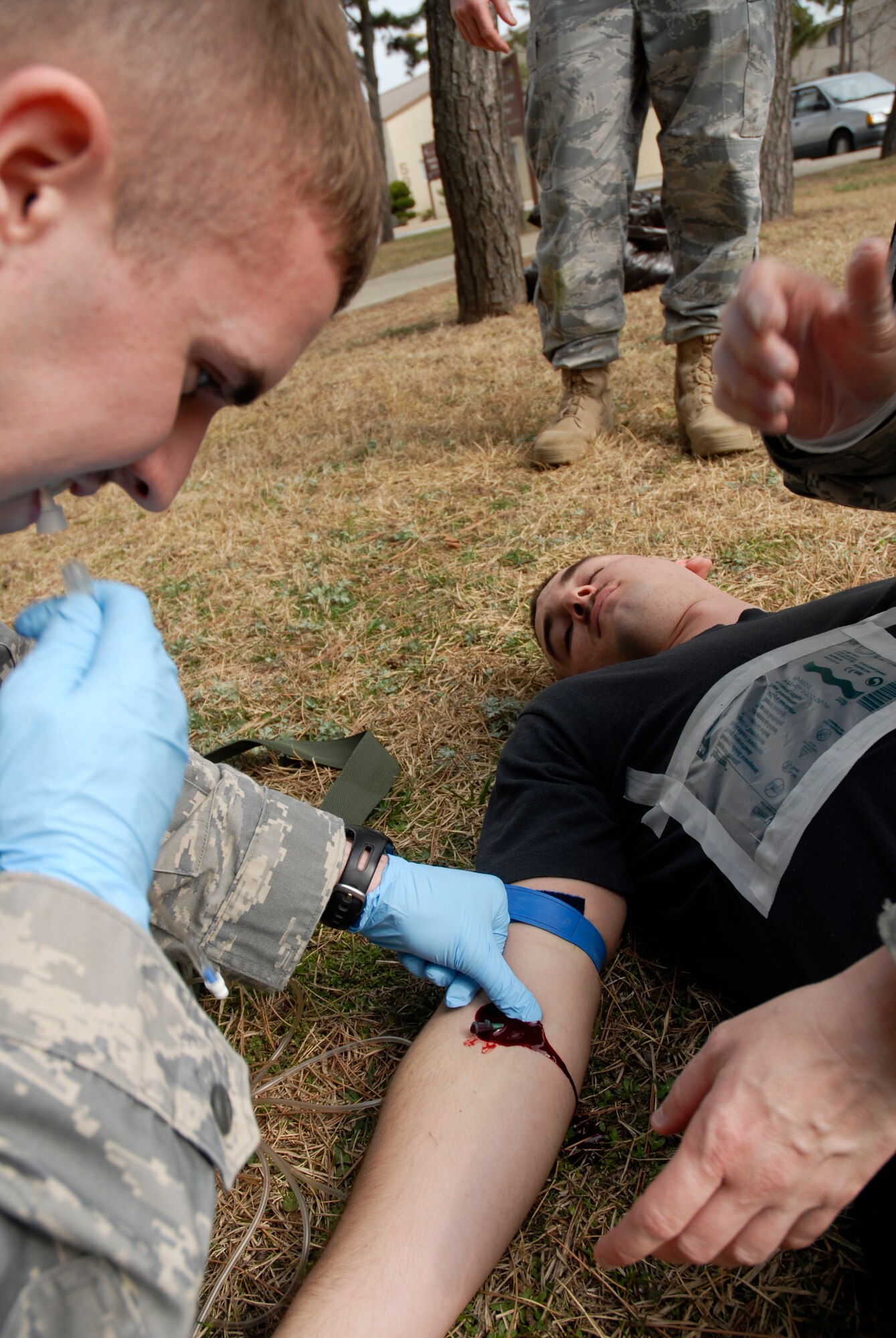 Airman 1st Class Nick Adkisson, 8th Civil Engineer Squadron, gives an intra-venus drip to Senior Airman Nathan Miller, 8 CES, during a Combat Life Saver training course at Kunsan Air Base, Republic of Korea, March 19, 2009. (U.S. Air Force Photo by SSgt Jason Colbert)