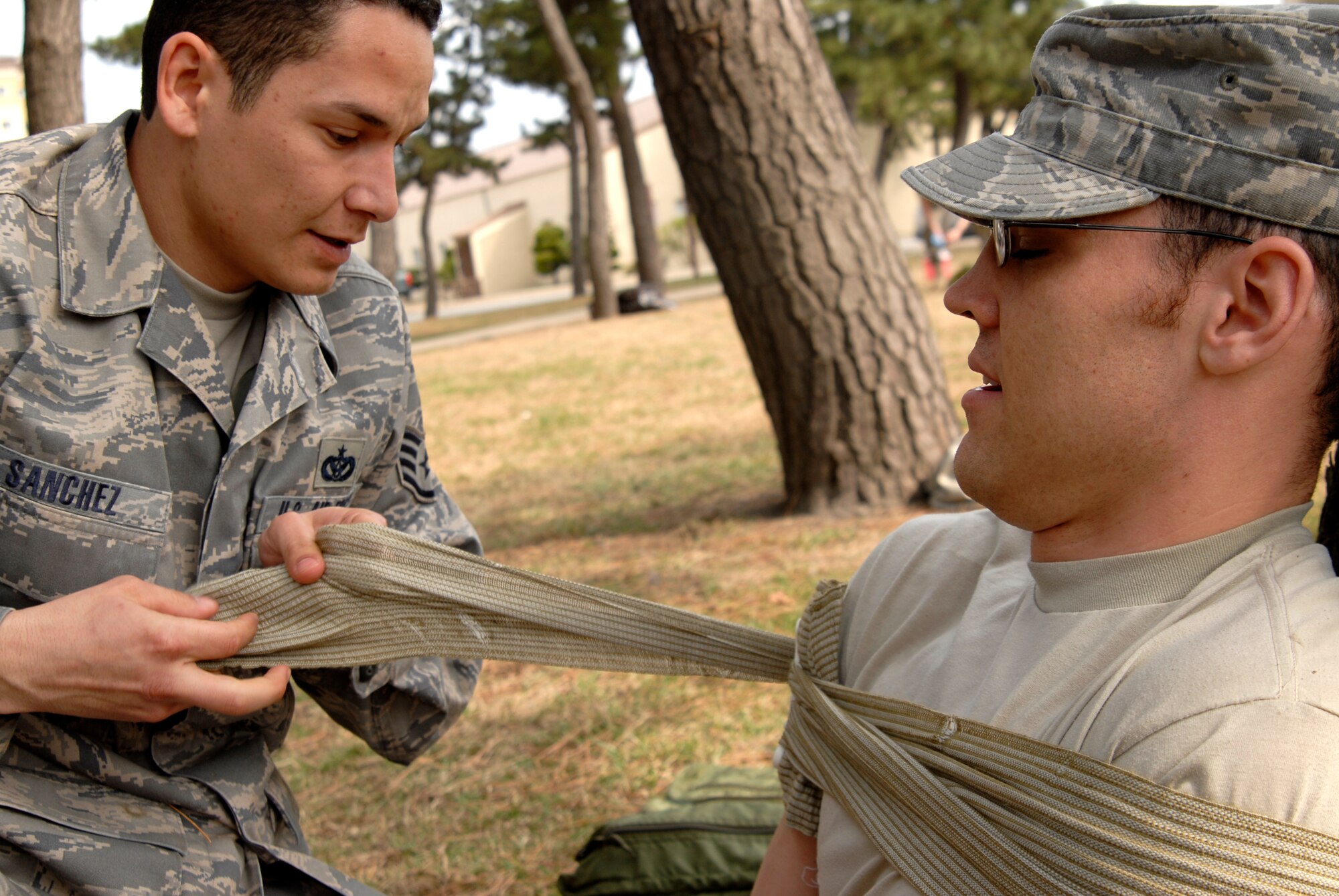 Staff Sgt Juan Sanchez, 8th Civil Engineer Squadron, secures the simulated shoulder wound of Senior Airman Nathan Miller, also 8 CES, during a Combat Life Saver training course at Kunsan Air Base, Republic of Korea, March 19, 2009. (U.S. Air Force Photo by SSgt Jason Colbert)