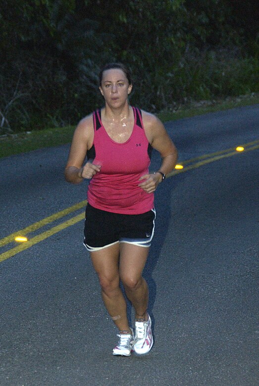 ANDERSEN AIR FORCE BASE, Guam -- Triathlon enthusiast, 2nd Lt. Sarah Mutter, 36th Mission Support Group executive officer, runs up Sanders Slope March 19 as part of her training regimen. Lieutenant Mutter currently runs six to 10 miles per week, swims at 3,000 meters and bikes at least 26 miles in preparation for the annaul XTerra Triathlon Competition on island. (U.S. Air Force photo by Airman Carissa Wolff)           