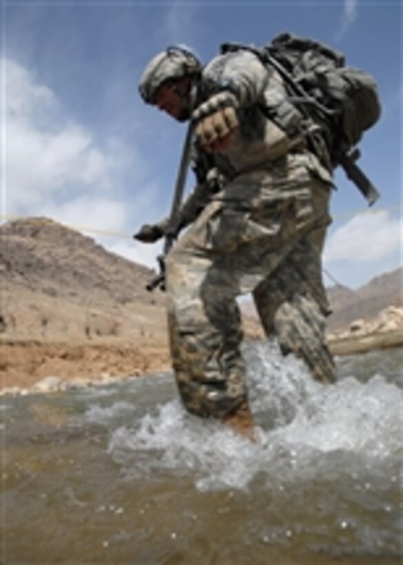 U.S. Army Spc. Nick Giovannelli from Bravo Company, 1st Battalion, 4th Infantry Regiment, U.S. Army Europe crosses a river while on a dismounted patrol mission near Forward Operating Base Baylough, Zabul, Afghanistan, on March 17, 2009.  