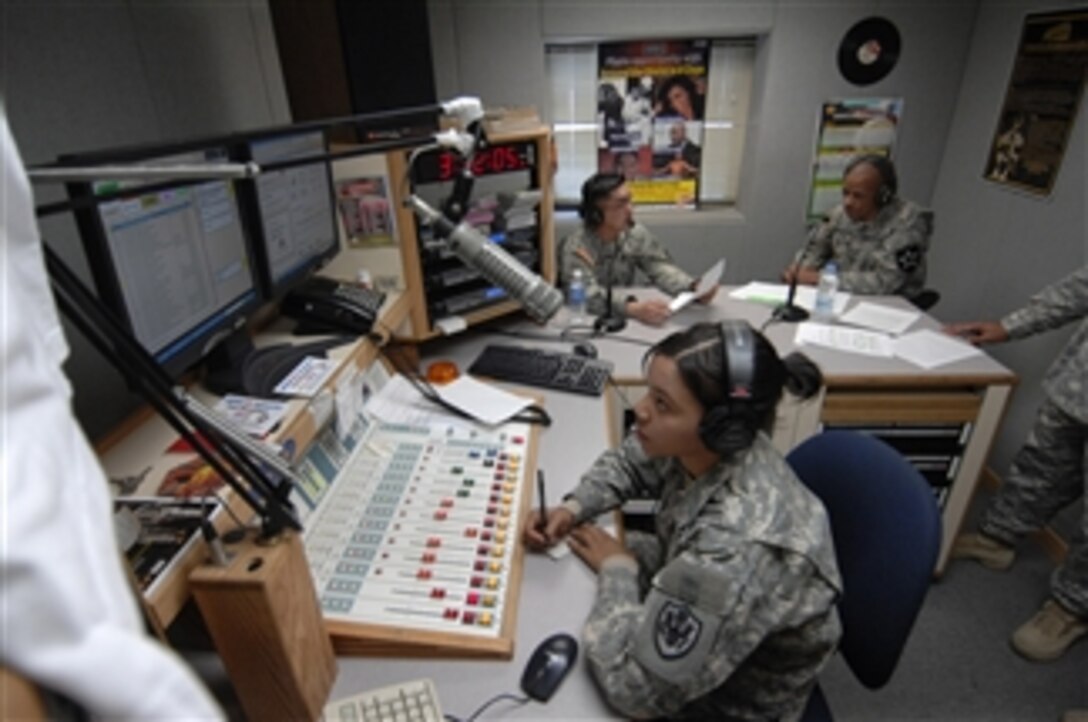 U.S. Army Sgt. Deyane Moses takes notes and monitors an audio level while Staff Sgt. Roberto Oson, American Forces Network, Camp Casey, Republic of Korea, interviews Sgt. Maj. Peter Burrowes, command sergeant major, 2nd Infantry Division, for the Warrior Wednesday show at Camp Casey on March 11, 2009.  The show, which focuses on warrior issues, is broadcast across the Korean peninsula every second Wednesday from 1530 to 1600.  