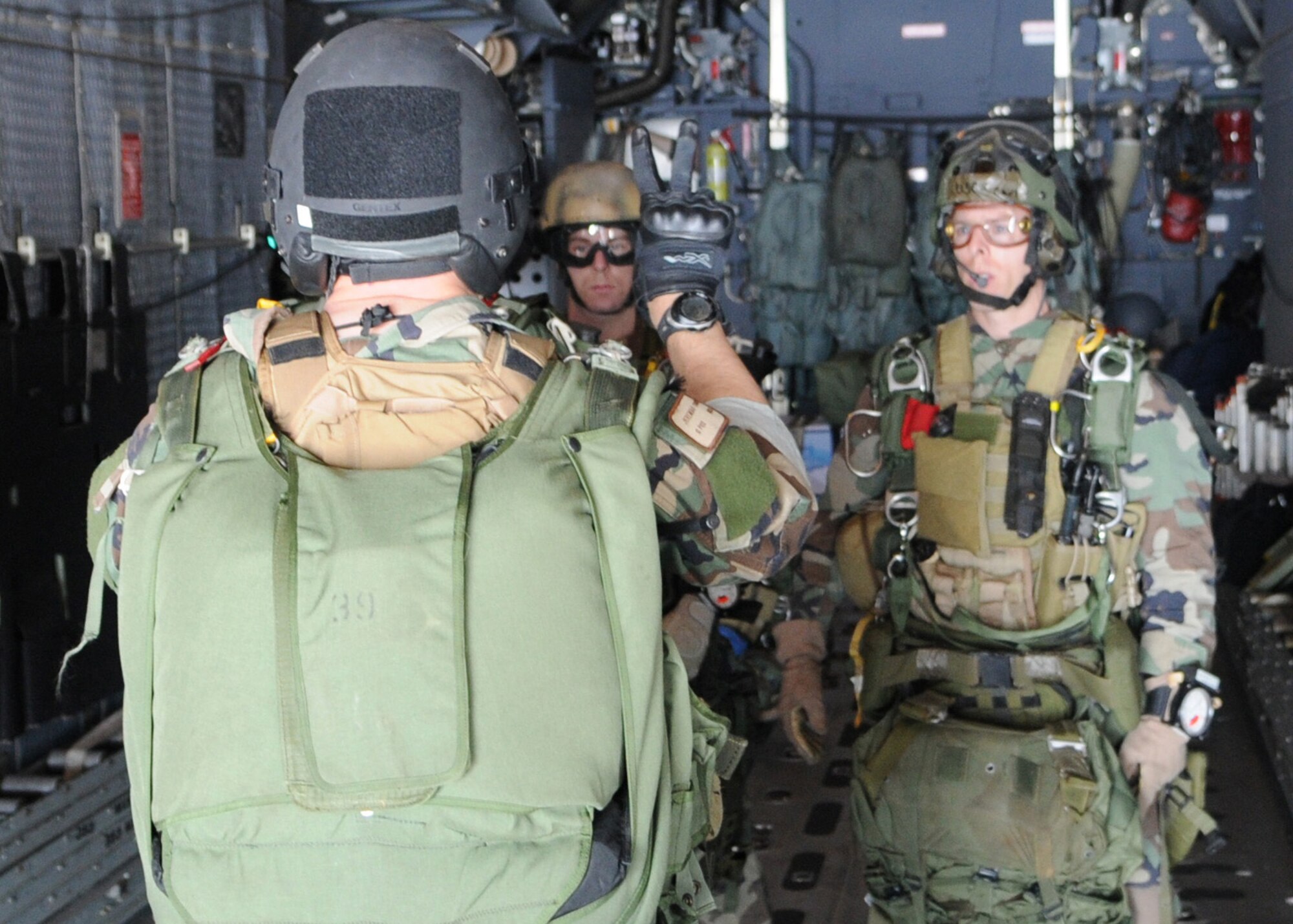 DAEGU AIR BASE, Republic of Korea -- A jumpmaster from the 320th Special Tactics Squadron give preparatory signals to other unit members before a high altitude, low opening jump from the back of a 1st Special Operations Squadron MC-130H Combat Talon II here March 19. The jump training is in preparation for the group's annual operational readiness exercise which affords unit members an opportunity to practice wartime skills necessary for their ability to survive and operate. The 353rd Special Operations Group is the focal point for all U.S. Air Force special operations activities throughout the U.S. Pacific Command theater. (U.S. Air Force photo by Tech. Sgt. Aaron Cram)
